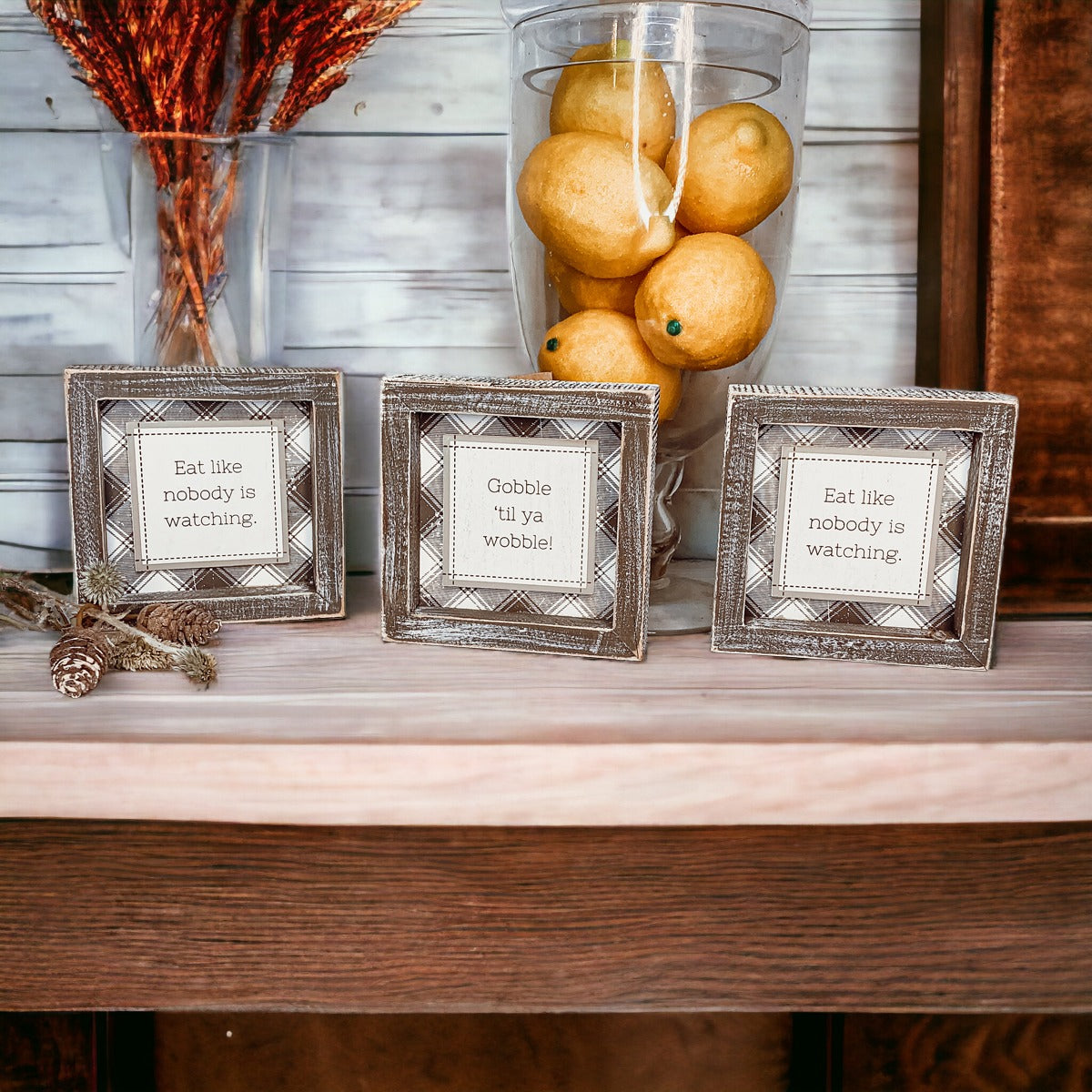 A decorative sign that reads 'Eat Like Nobody is Watching', measuring 5 inches by 5 inches, designed to hang or stand, perfect for kitchens or dining areas.