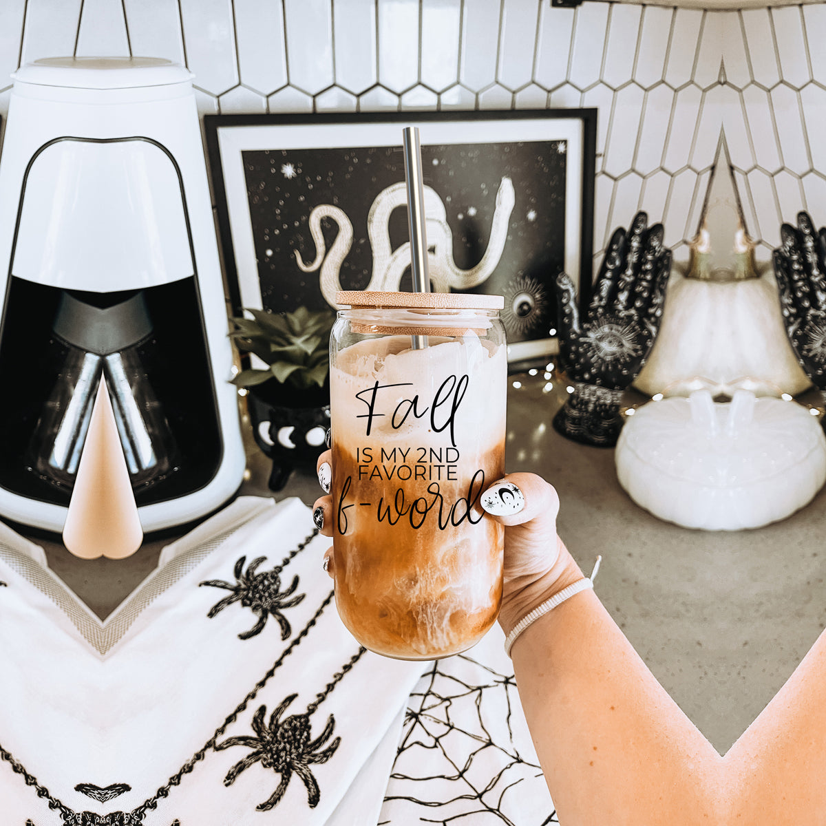 A stylish Fall F-Word Cup made of high borosilicate glass with a bamboo lid, featuring a black graphic text that reads 'FALL IS MY 2ND FAVORITE F-WORD', accompanied by stainless steel straws.