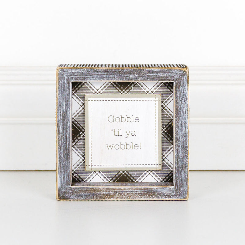 A charming Gobble Til Ya Wobble sign, perfect for Thanksgiving decor, featuring playful lettering on a compact wooden base.