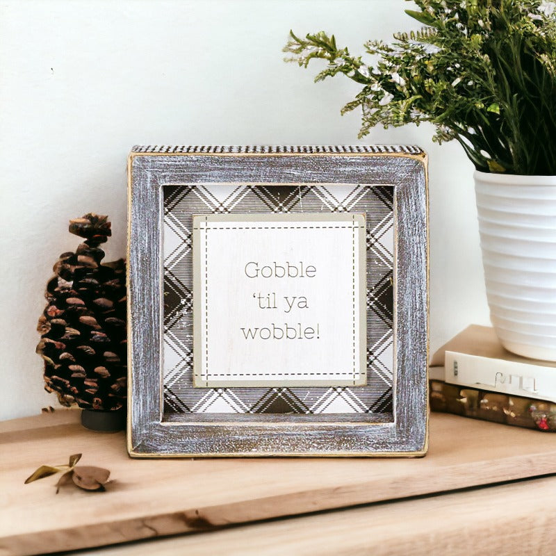 A charming Gobble Til Ya Wobble sign, perfect for Thanksgiving decor, featuring playful lettering on a compact wooden base.