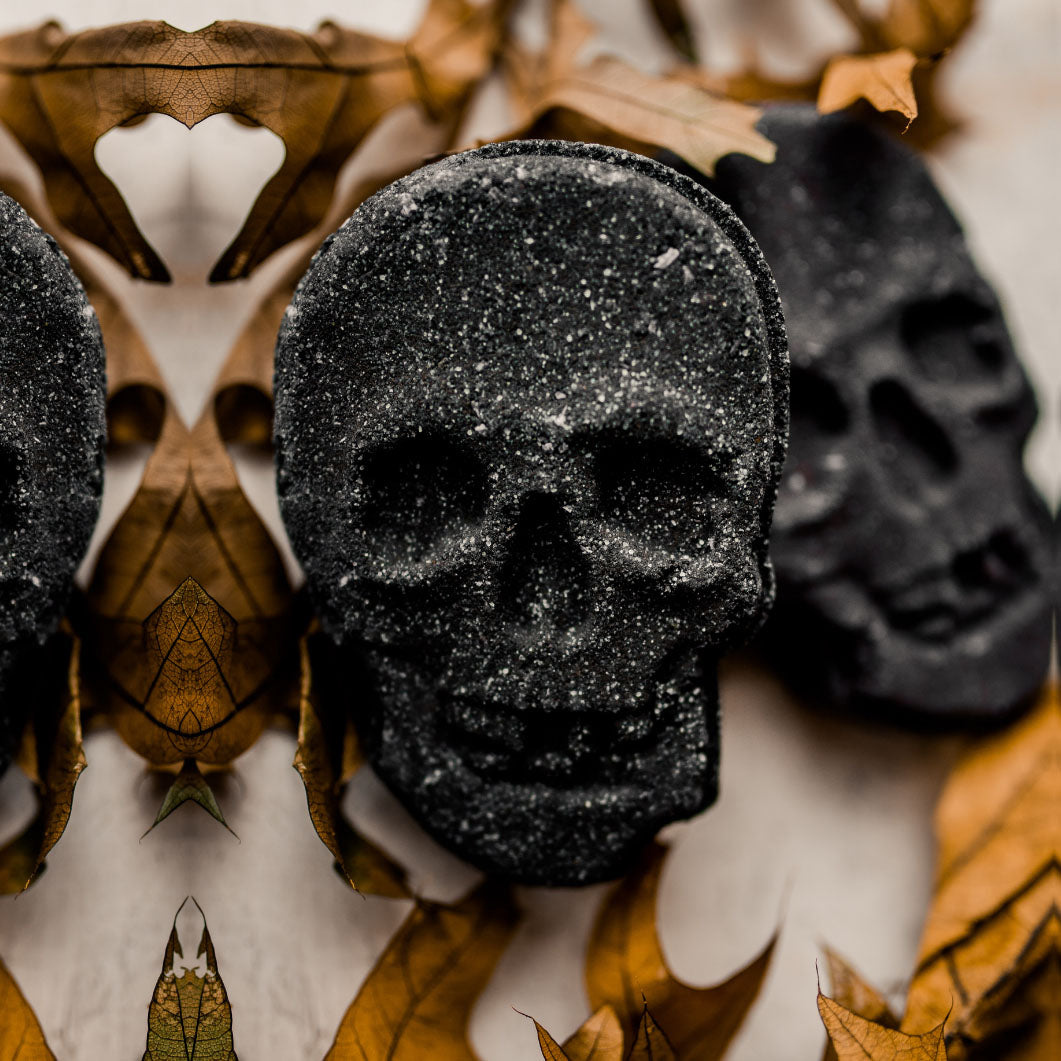 A large 5oz Halloween Skull Bath Bomb shaped like a skeleton skull, featuring a vibrant design and infused with eucalyptus and spearmint scents.