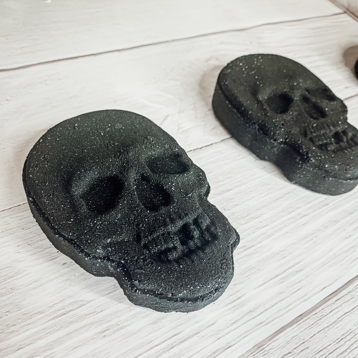 A large 5oz Halloween Skull Bath Bomb shaped like a skeleton skull, featuring a vibrant design and infused with eucalyptus and spearmint scents.