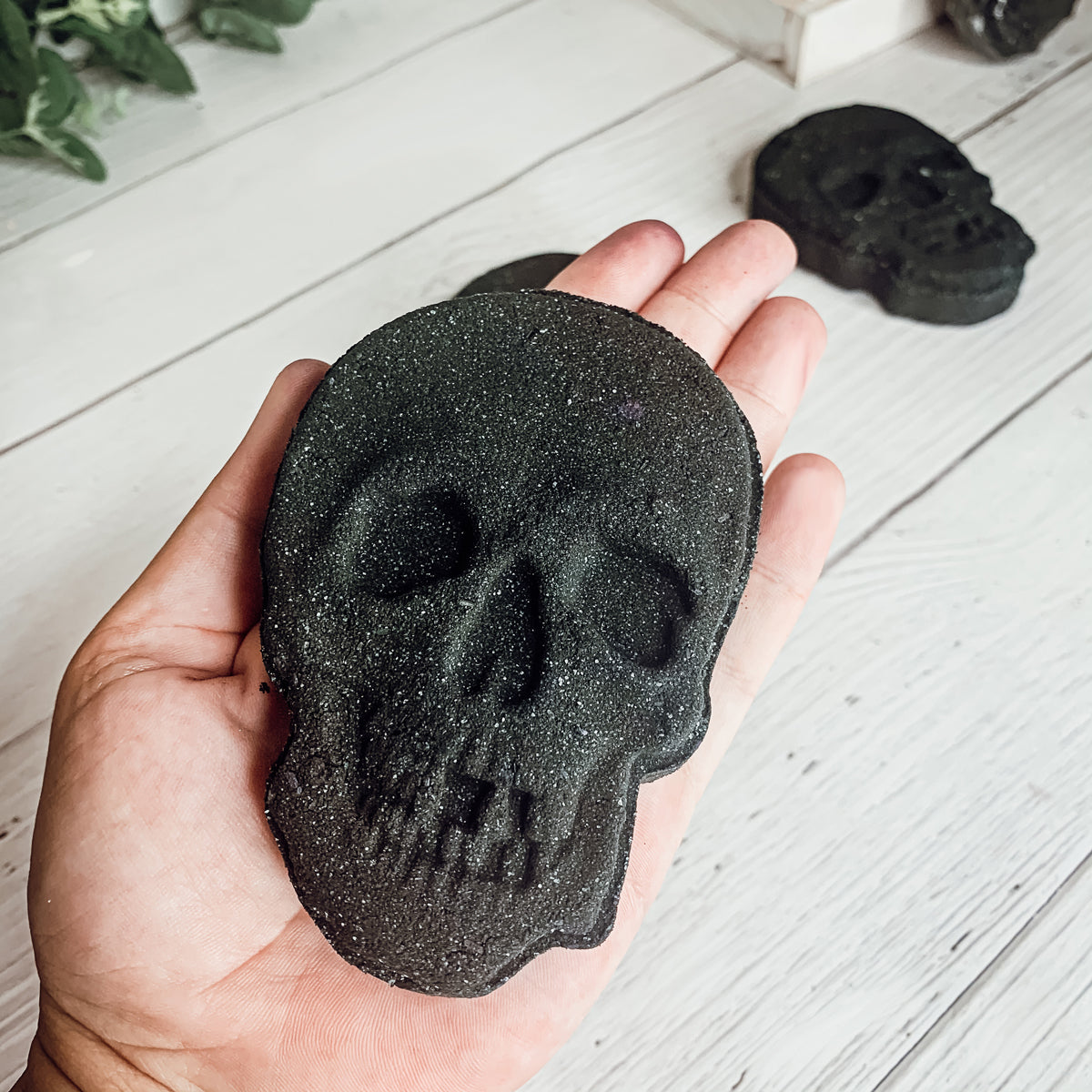 A large 5oz Halloween Skull Bath Bomb shaped like a skeleton skull, featuring a vibrant design and infused with eucalyptus and spearmint scents.