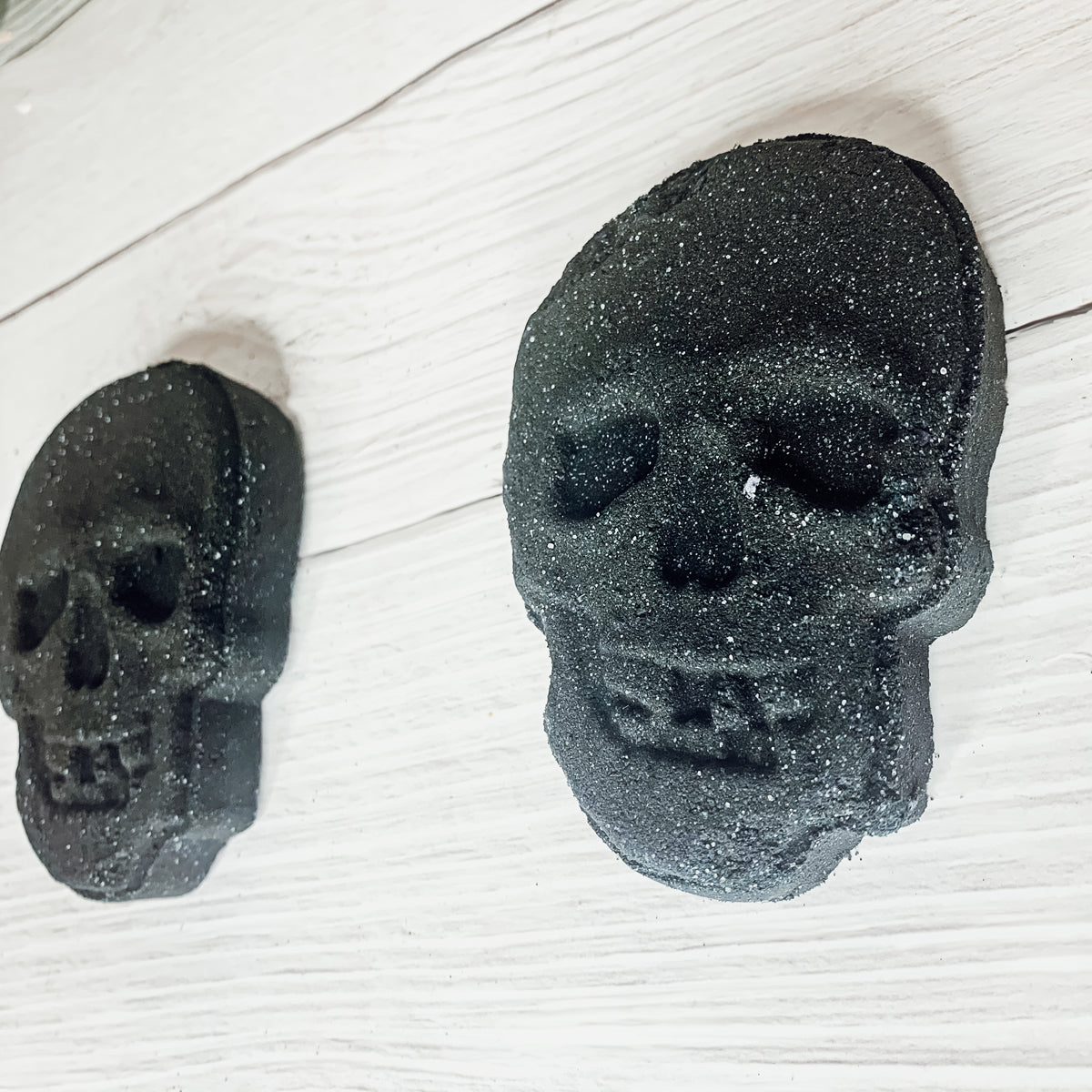 A large 5oz Halloween Skull Bath Bomb shaped like a skeleton skull, featuring a vibrant design and infused with eucalyptus and spearmint scents.