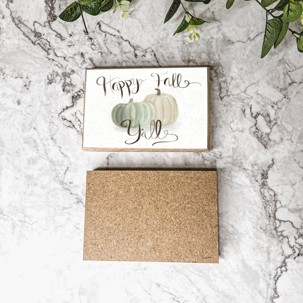 A charming wooden sign that reads 'Happy Fall Y'all' in pastel colors on an off-white background, perfect for autumn decor.