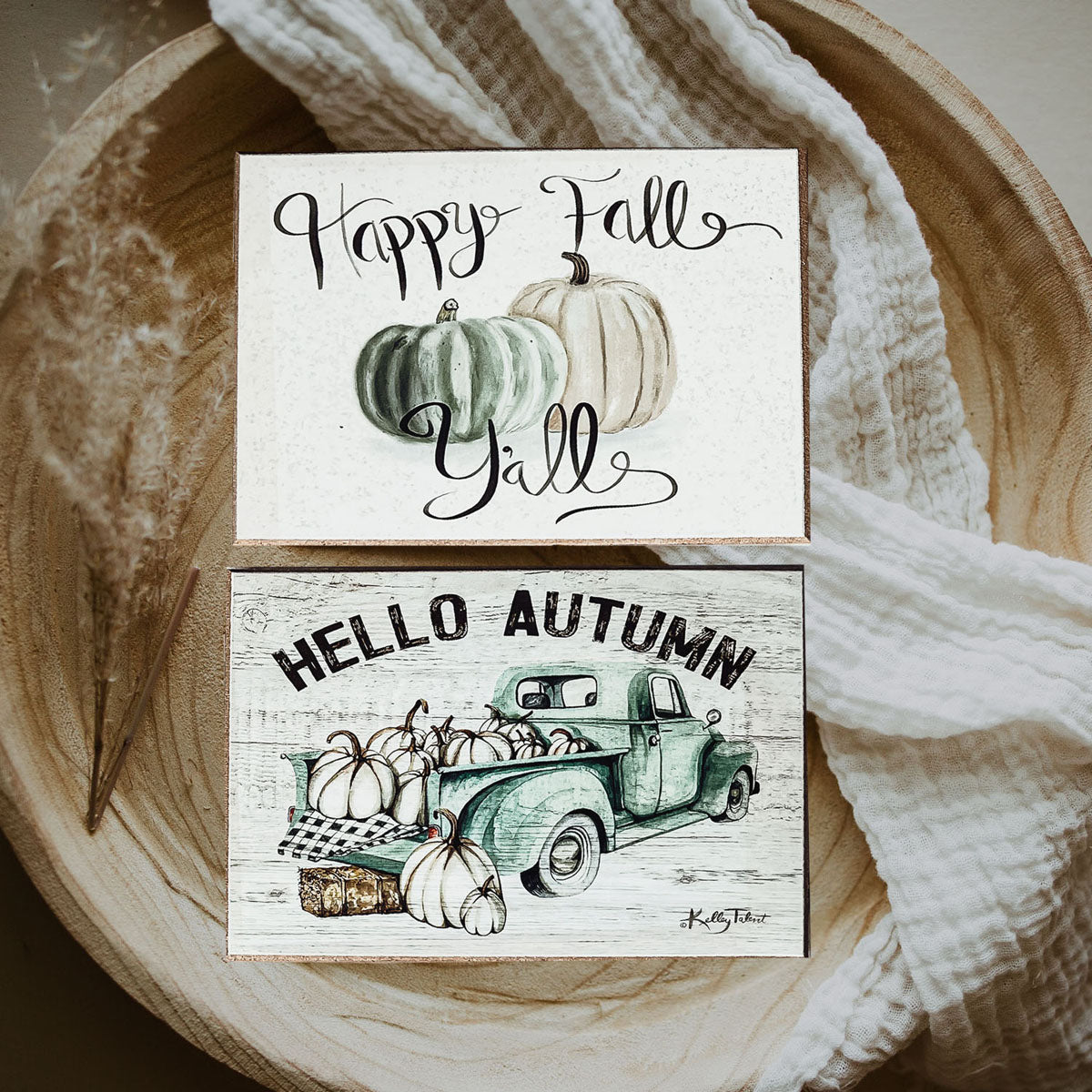 A charming wooden sign that reads 'Happy Fall Y'all' in pastel colors on an off-white background, perfect for autumn decor.