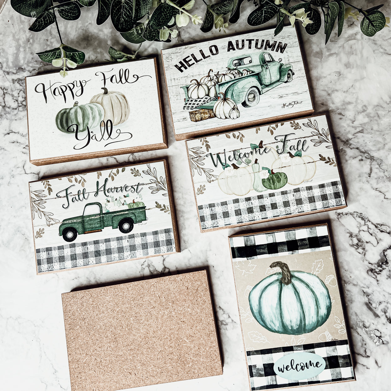 A charming wooden sign that reads 'Happy Fall Y'all' in pastel colors on an off-white background, perfect for autumn decor.