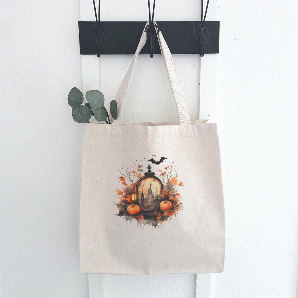 Haunted House Scene Canvas Tote Bag featuring a spooky design, heavy-duty fabric, and reinforced straps, perfect for eco-friendly shopping.