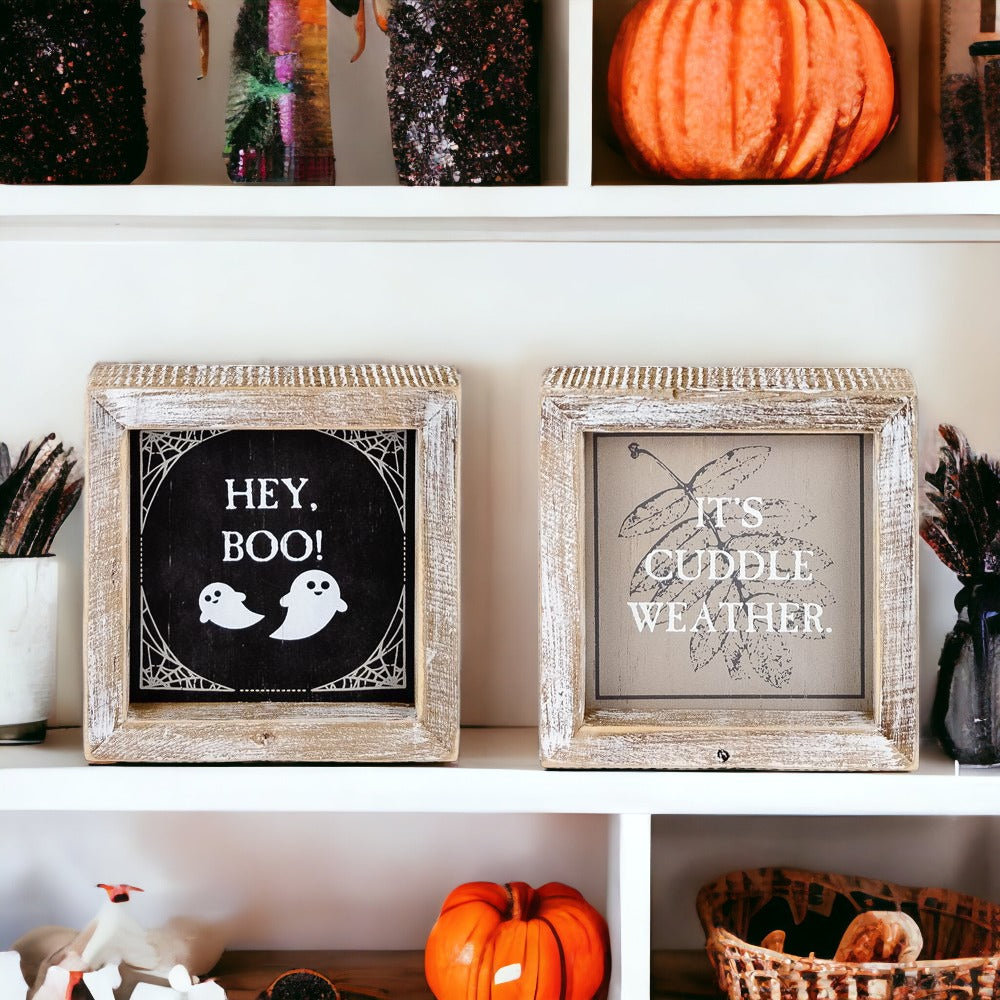 A double-sided wooden sign featuring 'Hey Boo' on one side and 'It's Cuddle Weather' on the other, measuring 5x5 inches.