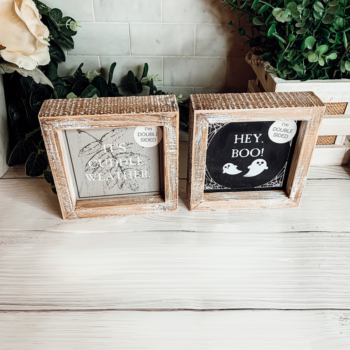 A double-sided wooden sign featuring 'Hey Boo' on one side and 'It's Cuddle Weather' on the other, measuring 5x5 inches.