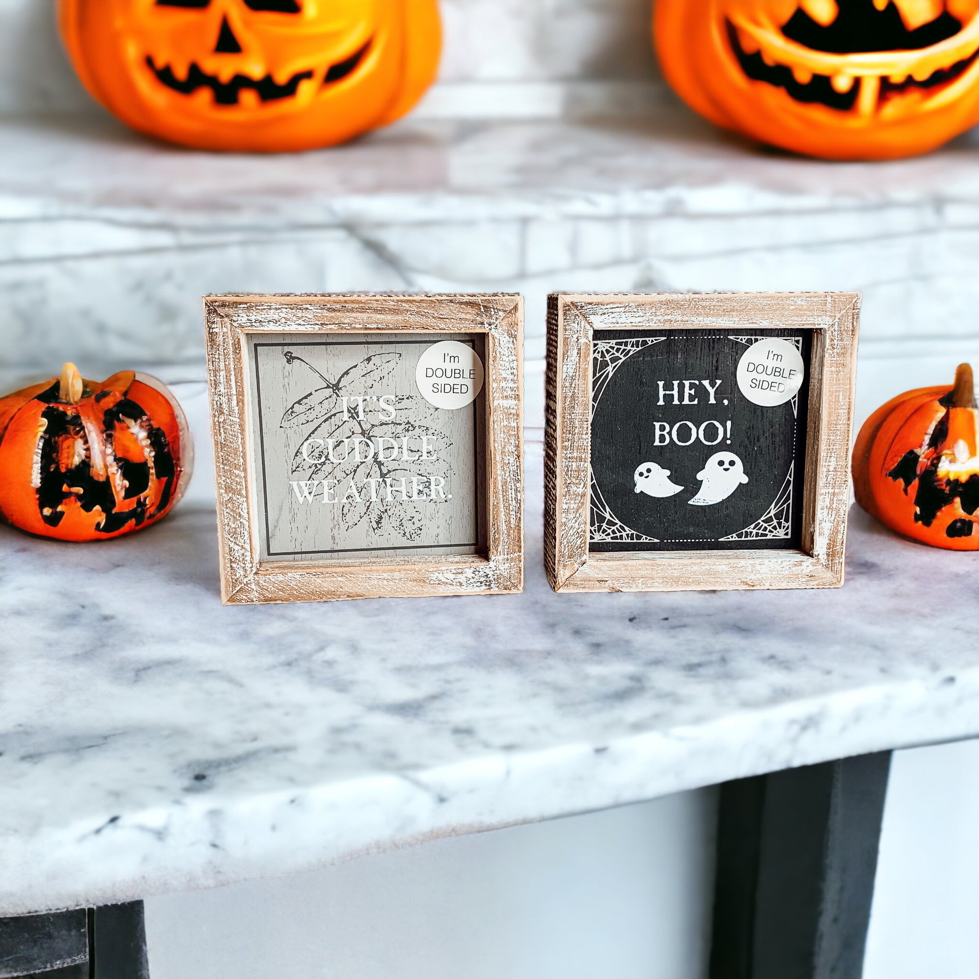 A double-sided wooden sign featuring 'Hey Boo' on one side and 'It's Cuddle Weather' on the other, measuring 5x5 inches.