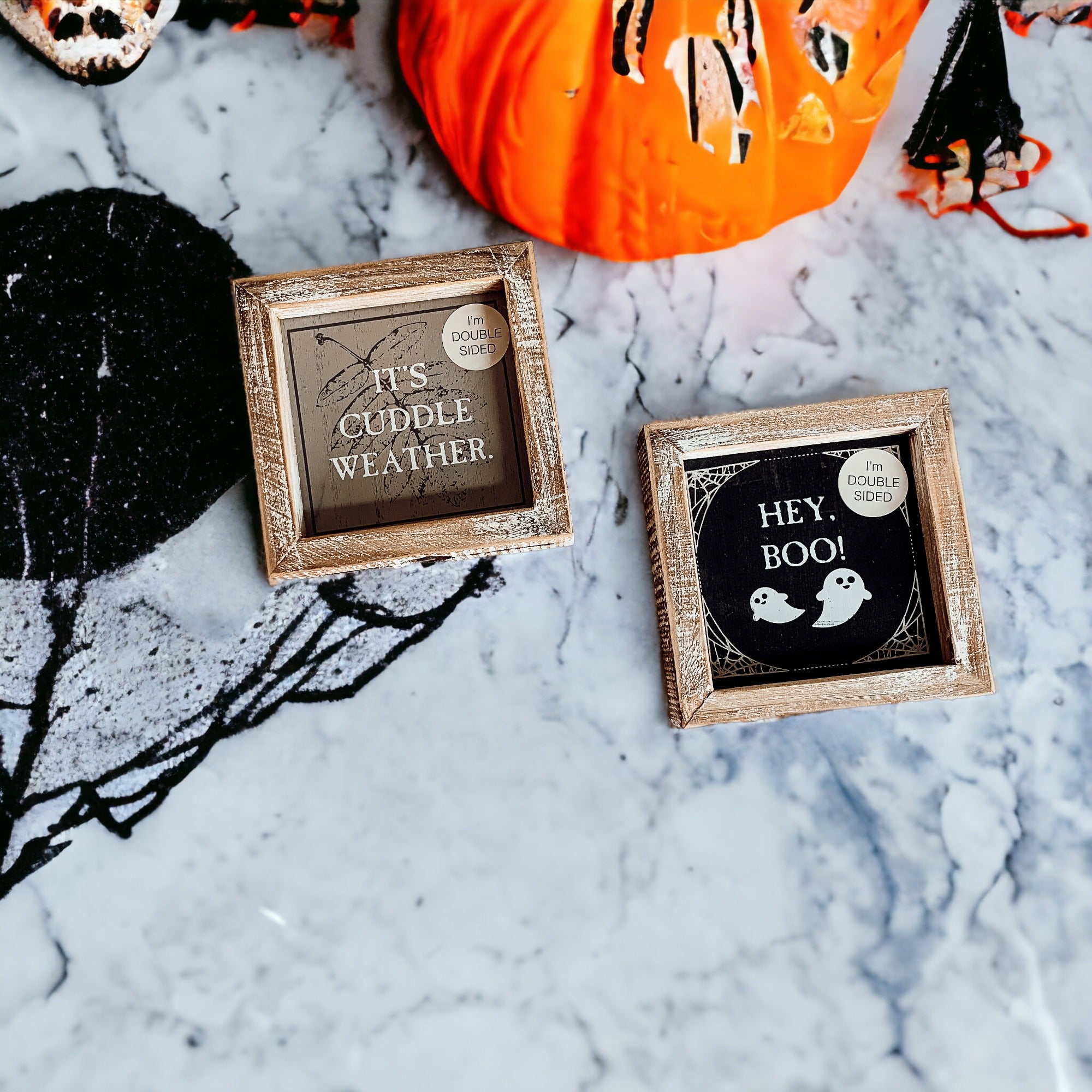 A double-sided wooden sign featuring 'Hey Boo' on one side and 'It's Cuddle Weather' on the other, measuring 5x5 inches.