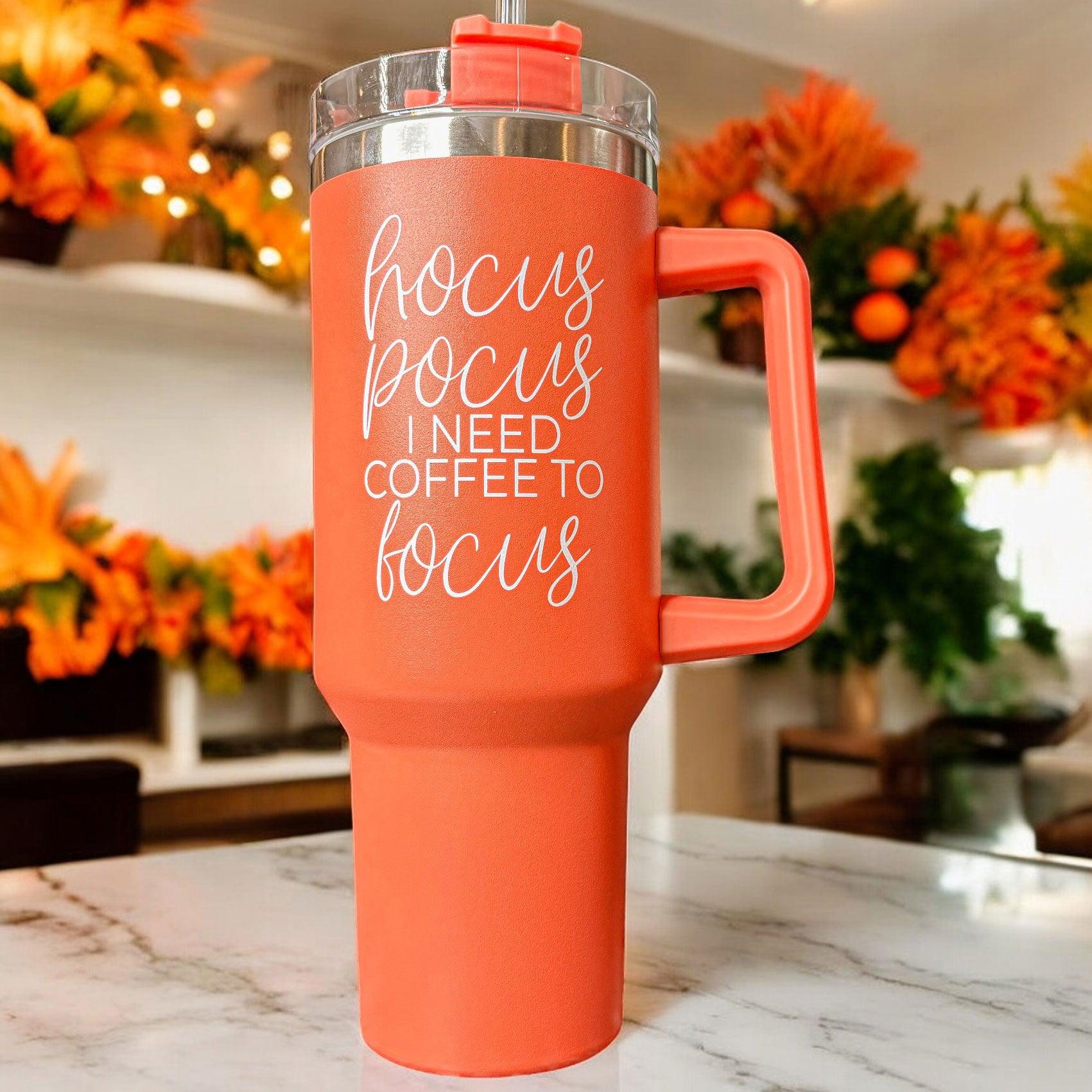 Hocus Pocus 40oz Tumbler in orange with lid and straw, featuring autumn leaves design.