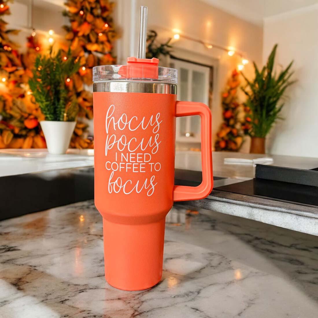 Hocus Pocus 40oz Tumbler in orange with lid and straw, featuring autumn leaves design.