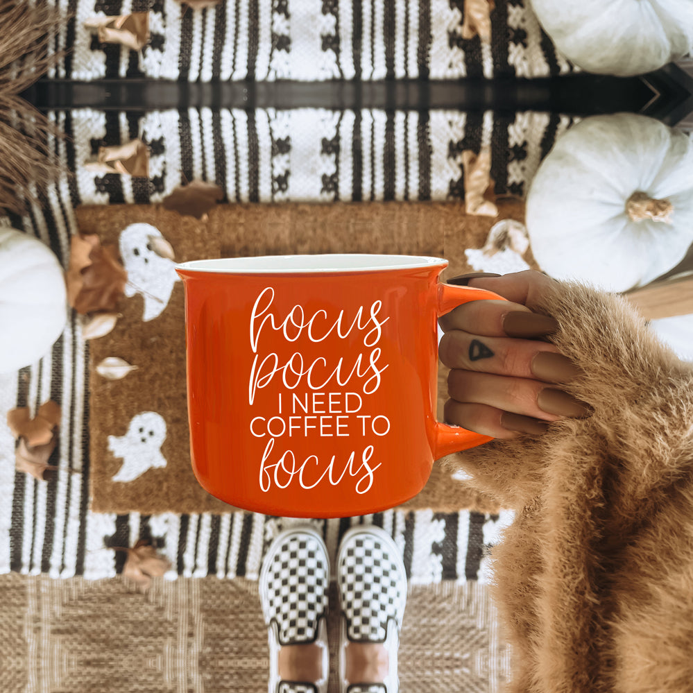 Hocus Pocus Mug in vibrant orange with white lettering, featuring the phrase 'Hocus Pocus I need Coffee to Focus!' on both sides, perfect for fall.