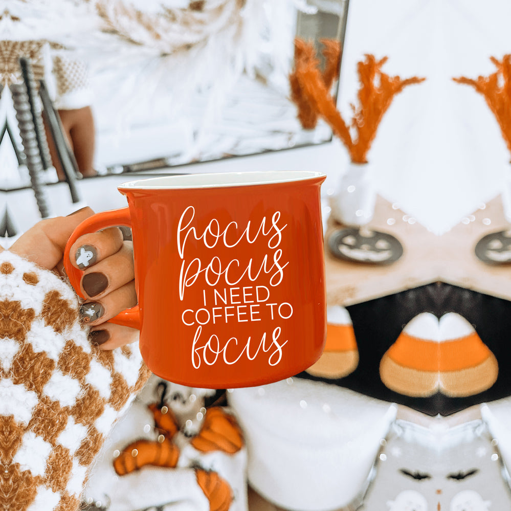 Hocus Pocus Mug in vibrant orange with white lettering, featuring the phrase 'Hocus Pocus I need Coffee to Focus!' on both sides, perfect for fall.