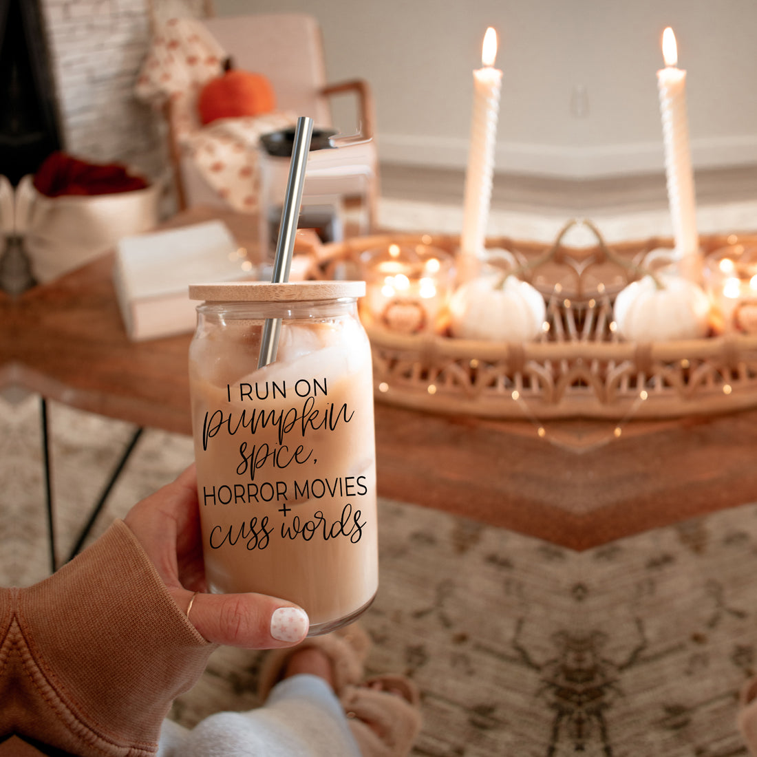 A stylish glass cup with a bamboo lid, featuring the phrase 'I RUN ON PUMPKIN SPICE, HORROR MOVIES + CUSS WORDS' in black graphic design.