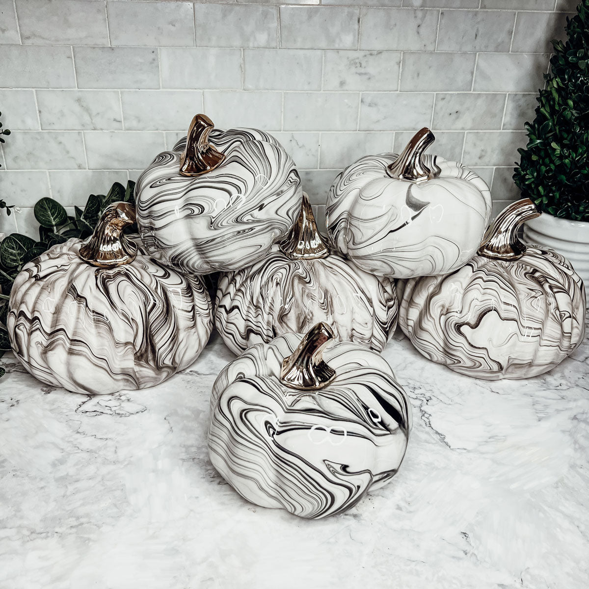 Martha Black Pumpkin featuring a unique marbled design and a luxurious gold-toned metallic stem, perfect for Halloween and year-round decor.