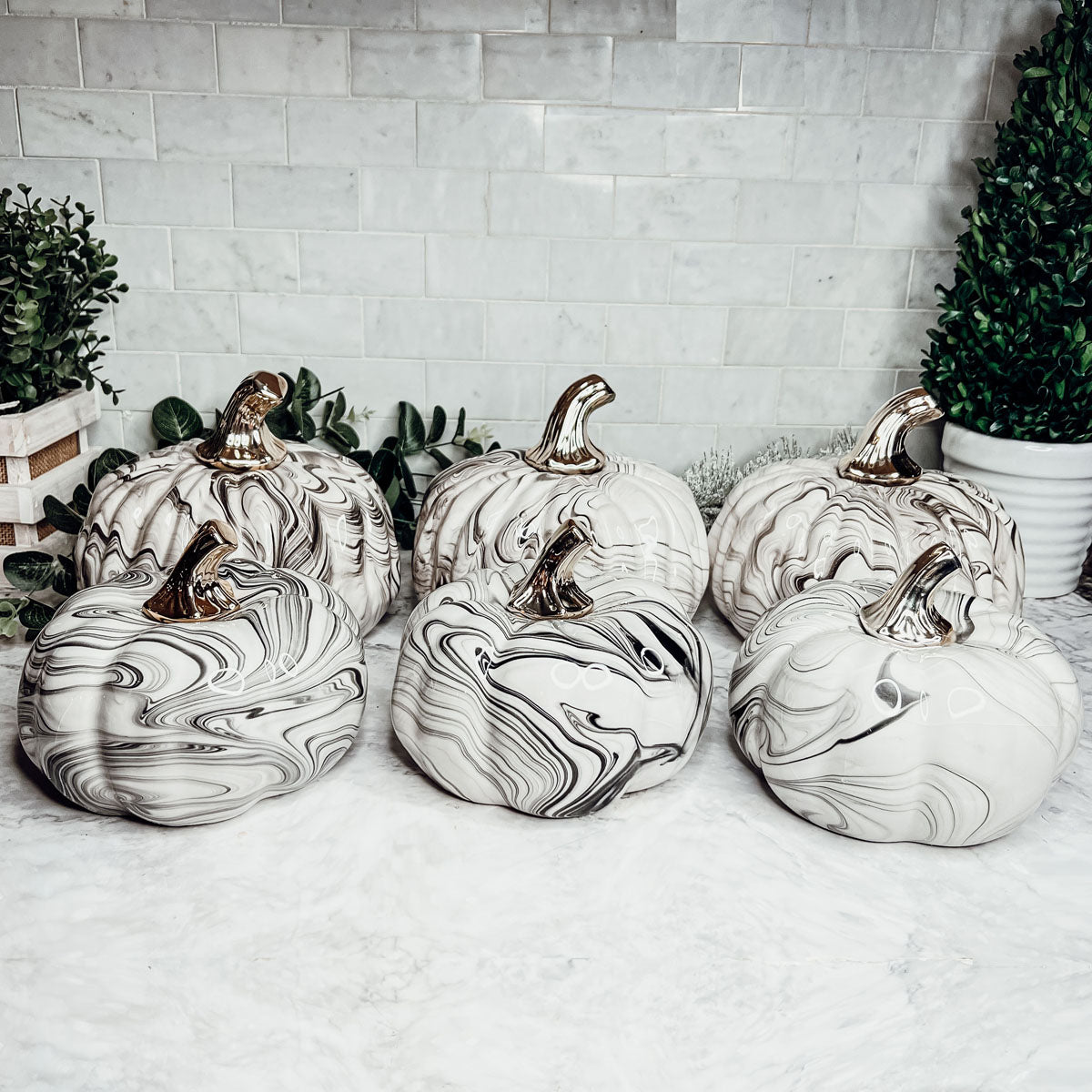 Martha Black Pumpkin featuring a unique marbled design and a luxurious gold-toned metallic stem, perfect for Halloween and year-round decor.