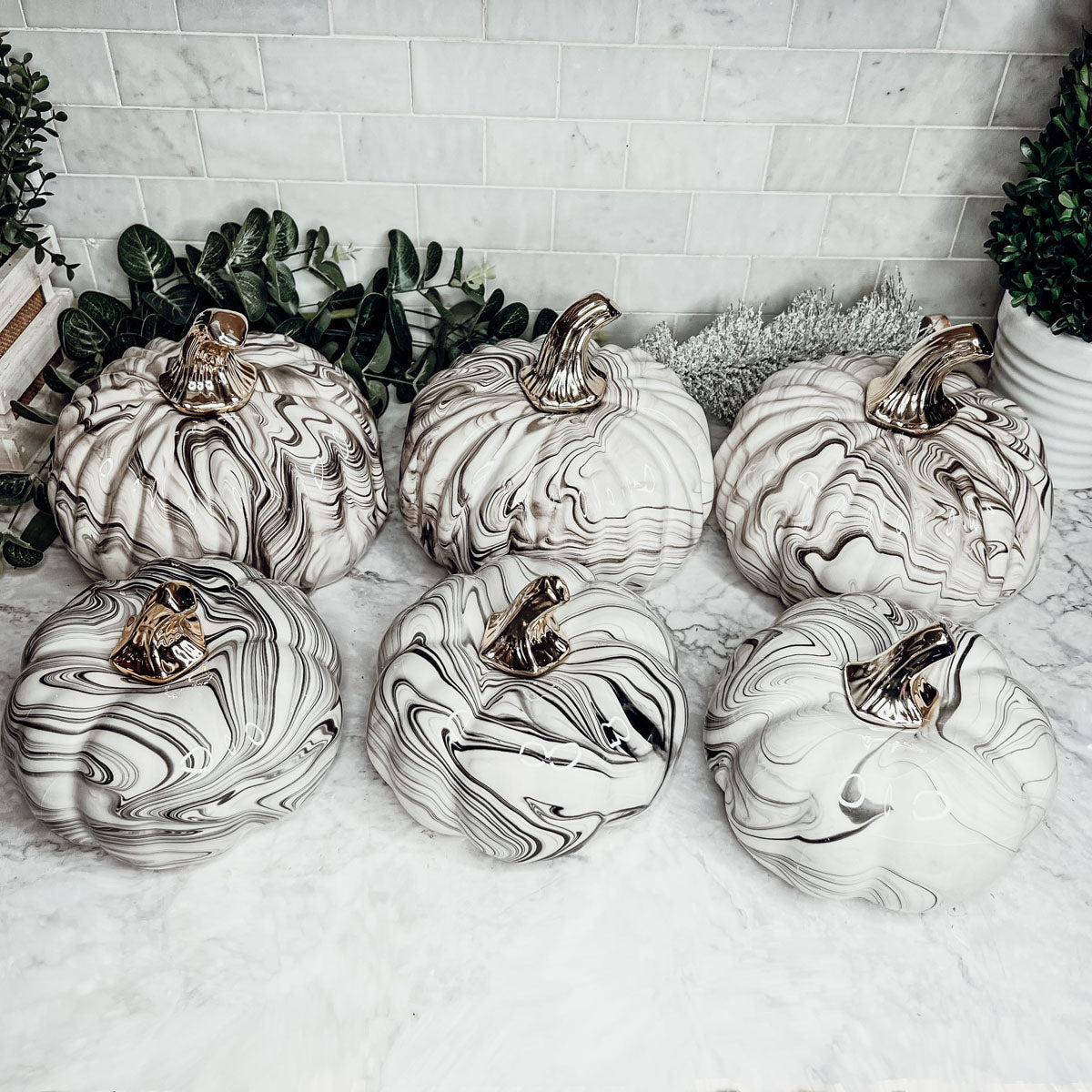 Martha Black Pumpkin featuring a unique marbled design and a luxurious gold-toned metallic stem, perfect for Halloween and year-round decor.