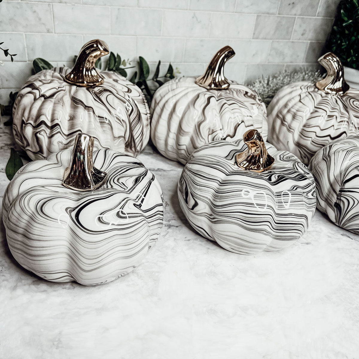 Martha Black Pumpkin featuring a unique marbled design and a luxurious gold-toned metallic stem, perfect for Halloween and year-round decor.