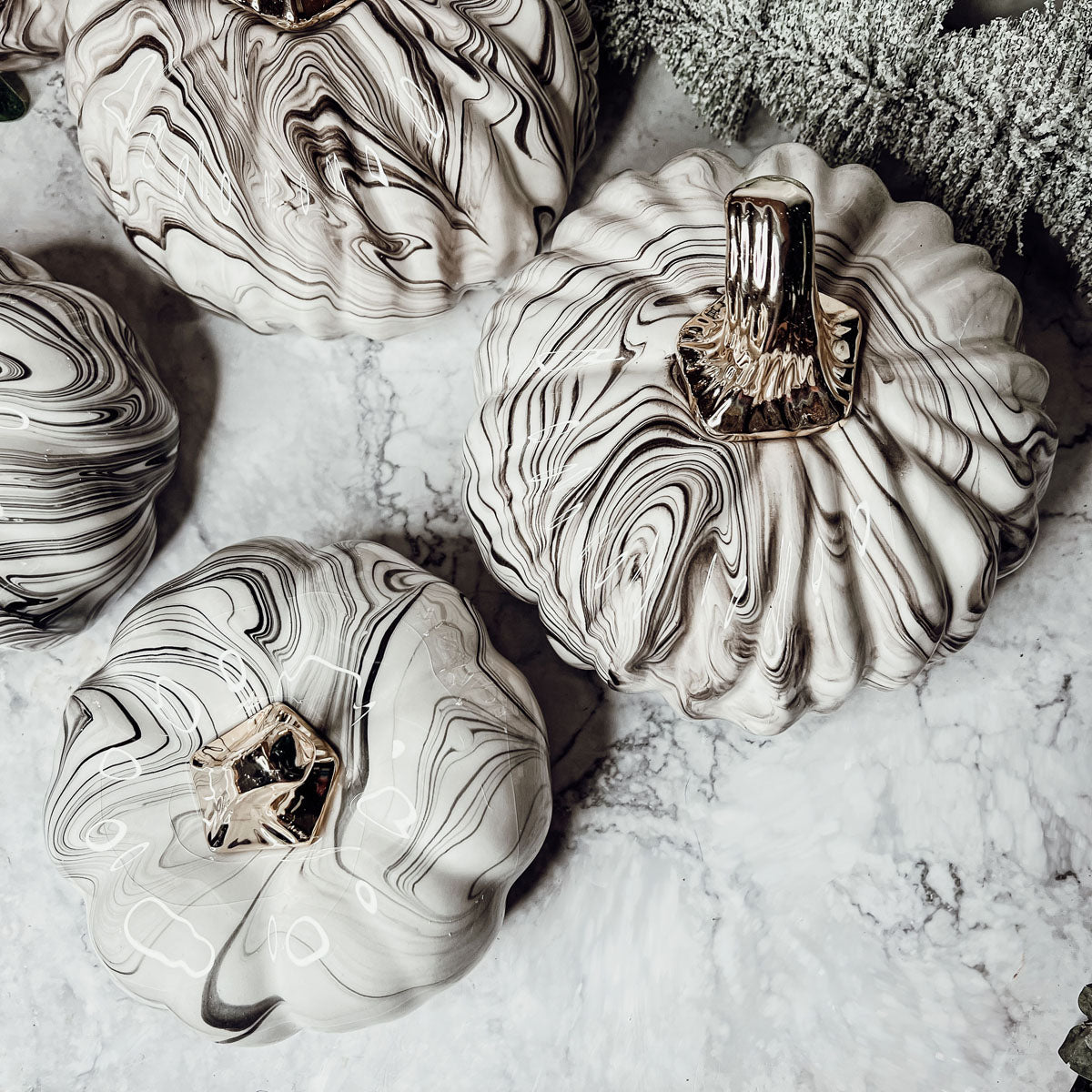 Martha Black Pumpkin featuring a unique marbled design and a luxurious gold-toned metallic stem, perfect for Halloween and year-round decor.