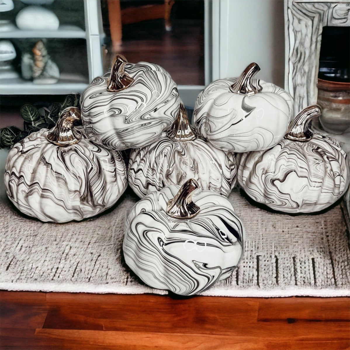 Martha Black Pumpkin featuring a unique marbled design and a luxurious gold-toned metallic stem, perfect for Halloween and year-round decor.