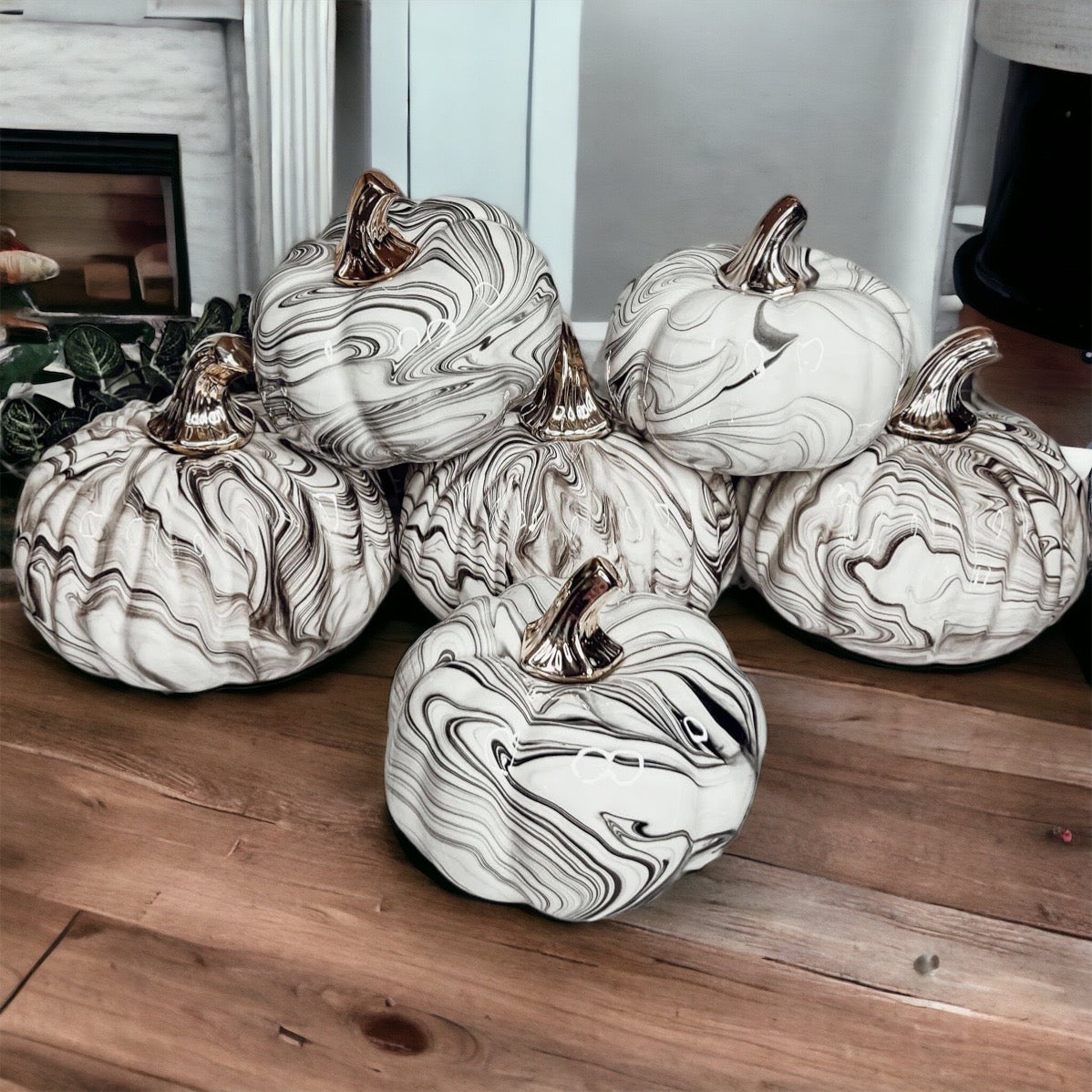 Martha Black Pumpkin featuring a unique marbled design and a luxurious gold-toned metallic stem, perfect for Halloween and year-round decor.