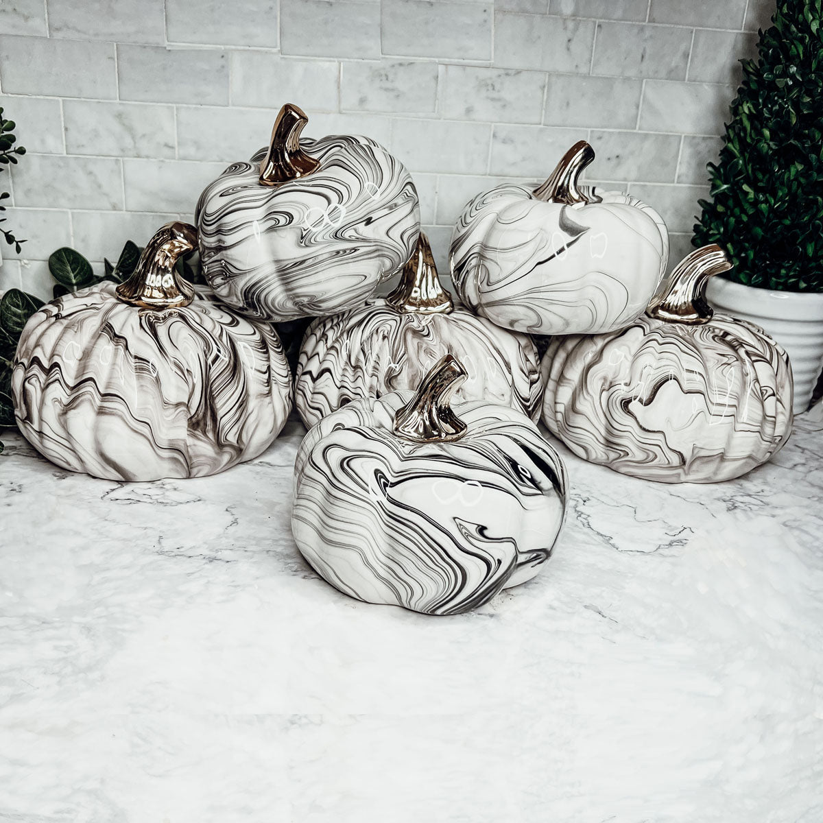 Martha Black Pumpkin featuring a unique marbled design and a luxurious gold-toned metallic stem, perfect for Halloween and year-round decor.