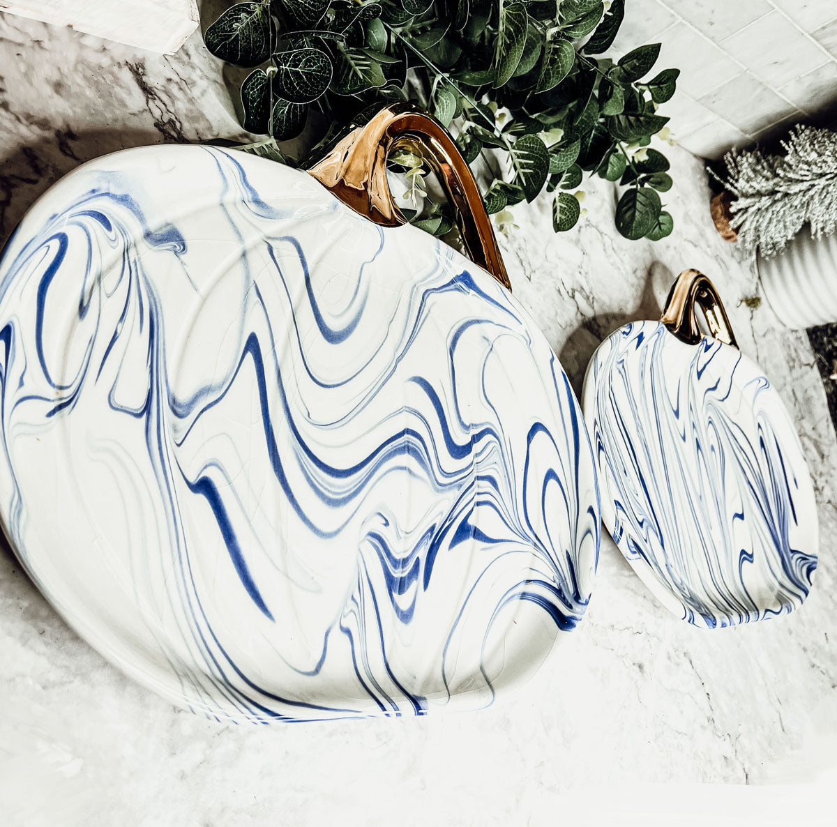 Martha Blue Pumpkin Plate set featuring marbled blue and white design with elegant gold stems, perfect for serving desserts.