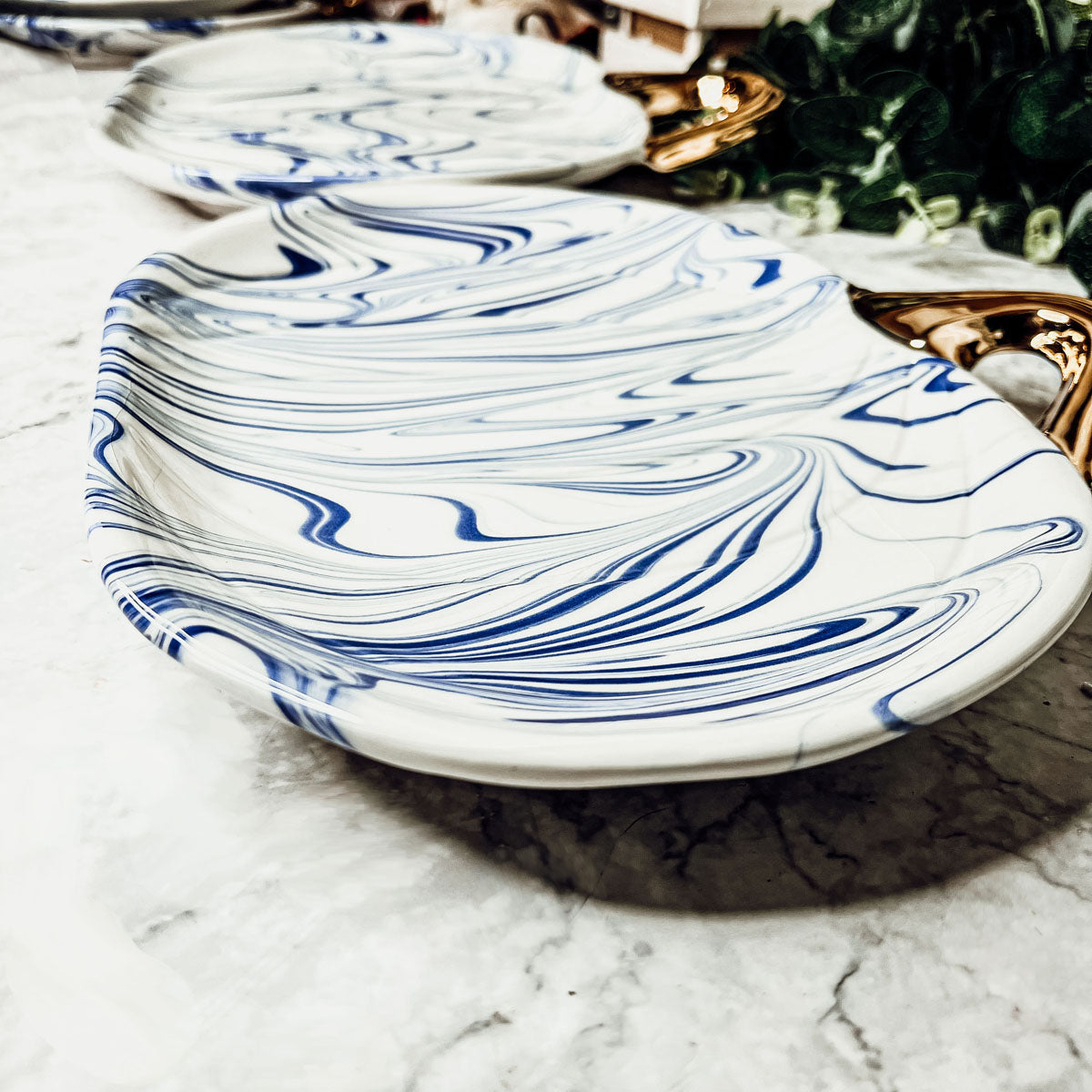 Martha Blue Pumpkin Plate set featuring marbled blue and white design with elegant gold stems, perfect for serving desserts.