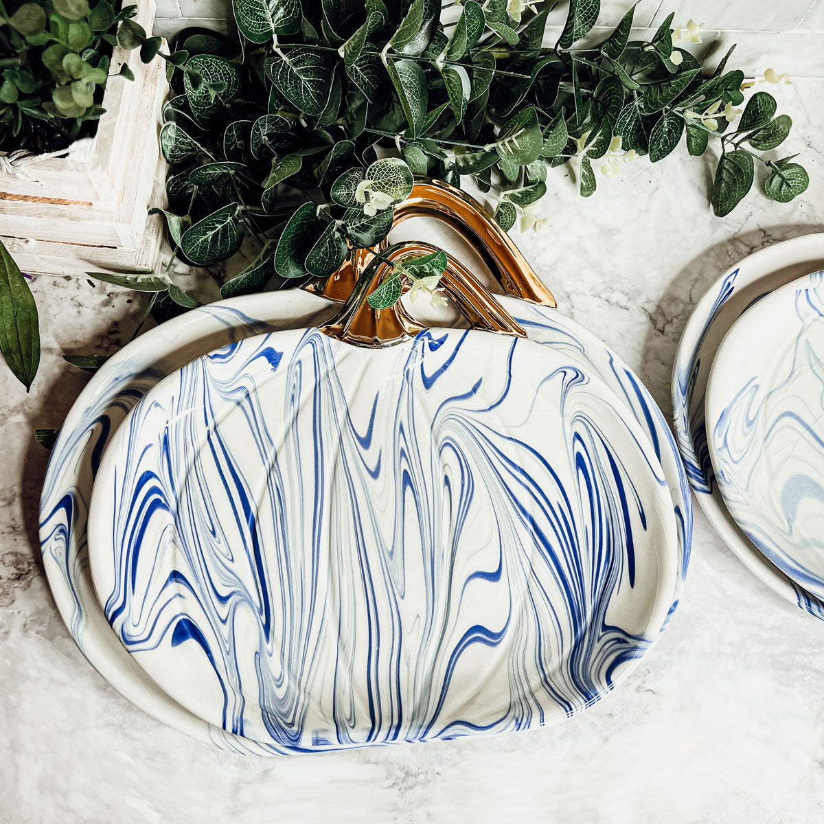 Martha Blue Pumpkin Plate set featuring marbled blue and white design with elegant gold stems, perfect for serving desserts.