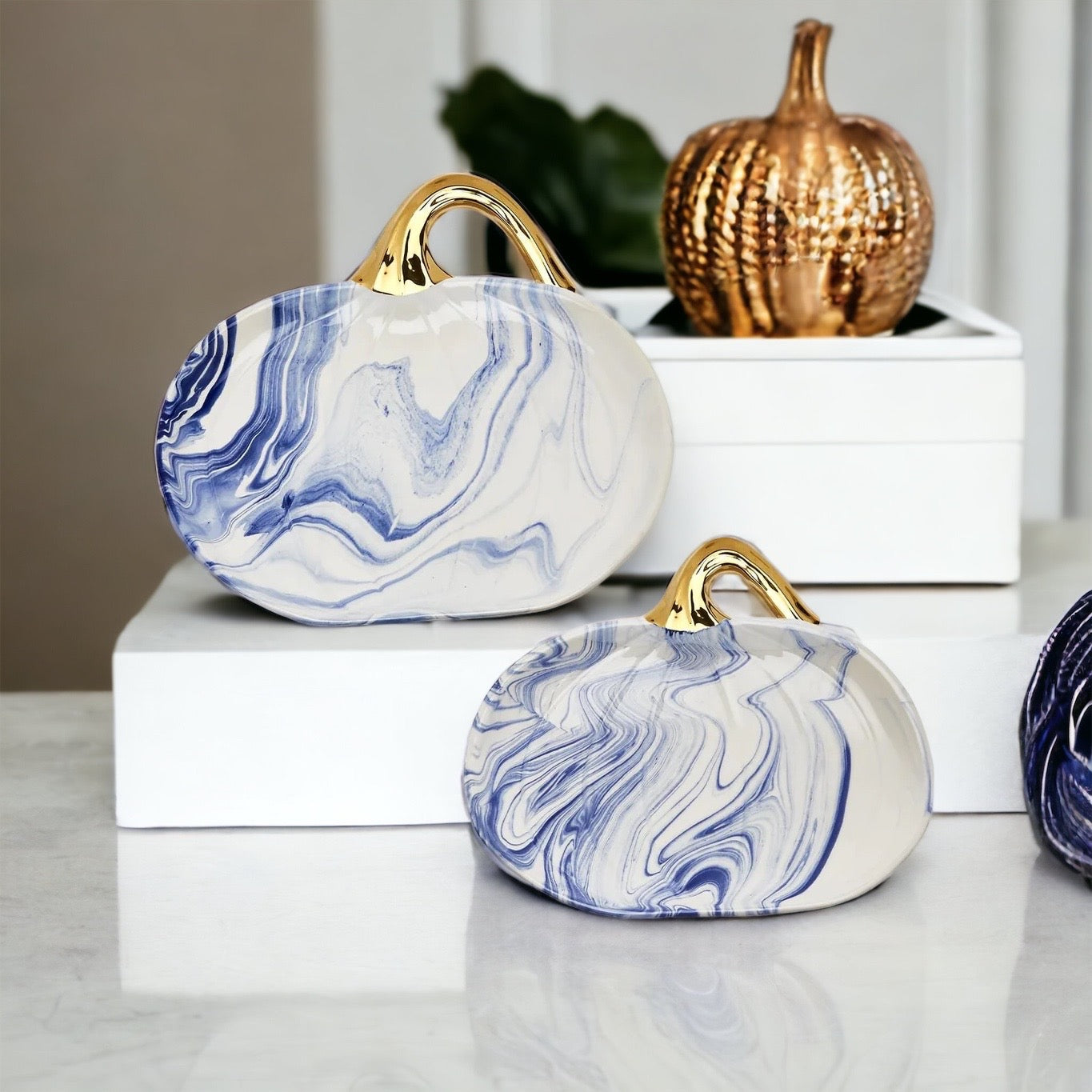 Martha Blue Pumpkin Plate set featuring marbled blue and white design with elegant gold stems, perfect for serving desserts.