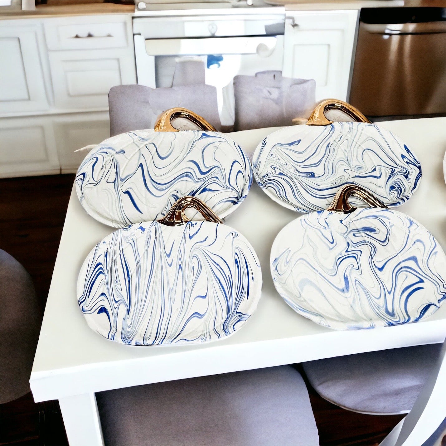 Martha Blue Pumpkin Plate set featuring marbled blue and white design with elegant gold stems, perfect for serving desserts.