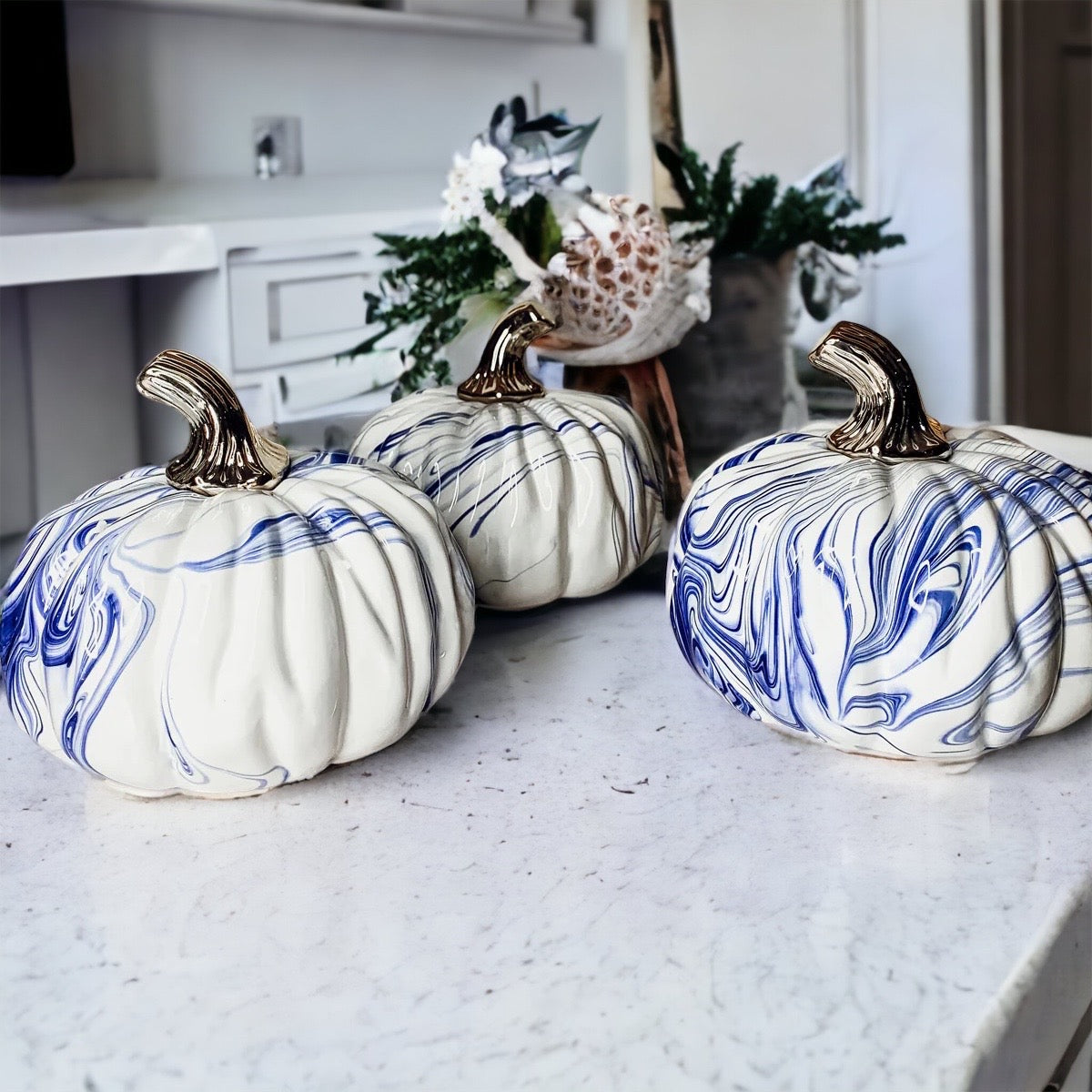 A stunning marbled blue pumpkin, handcrafted from dolomite, showcasing unique designs and elegant curves, perfect for Halloween decor.