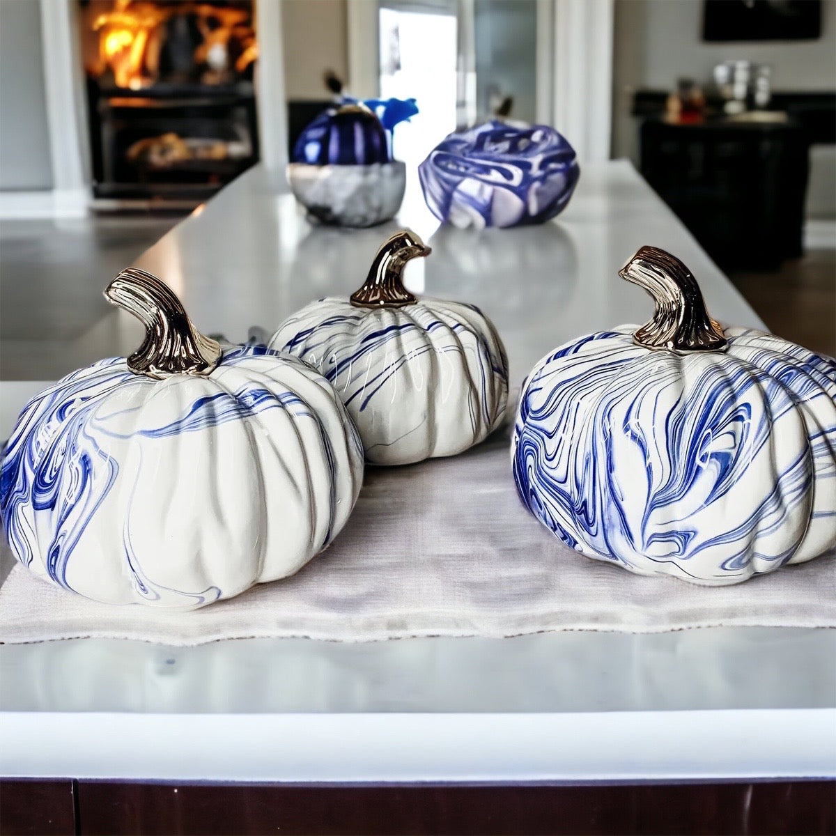 A stunning marbled blue pumpkin, handcrafted from dolomite, showcasing unique designs and elegant curves, perfect for Halloween decor.