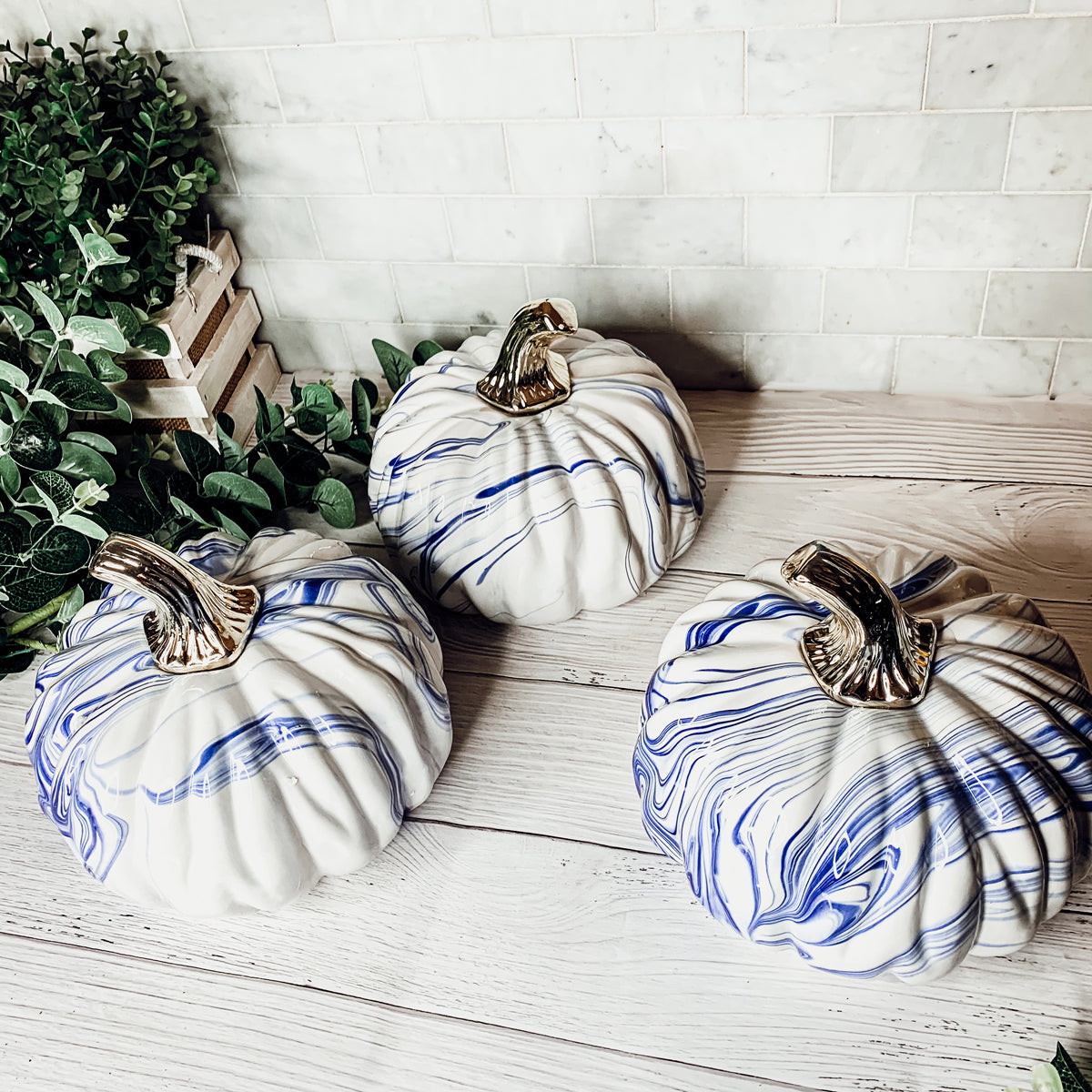 A stunning marbled blue pumpkin, handcrafted from dolomite, showcasing unique designs and elegant curves, perfect for Halloween decor.