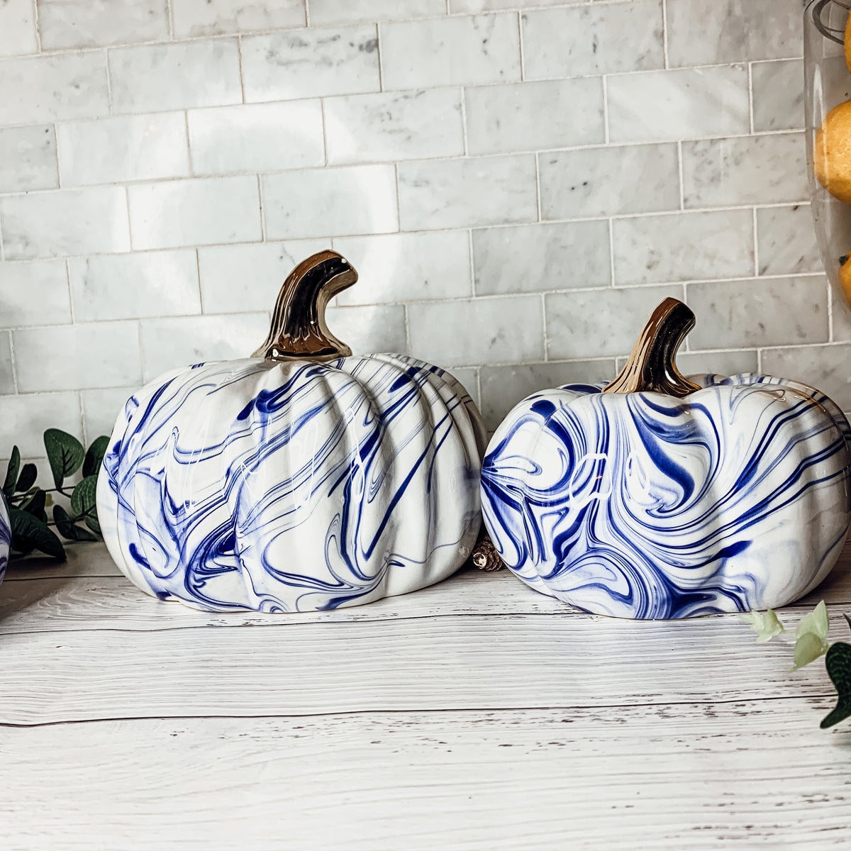 A stunning marbled blue pumpkin, handcrafted from dolomite, showcasing unique designs and elegant curves, perfect for Halloween decor.