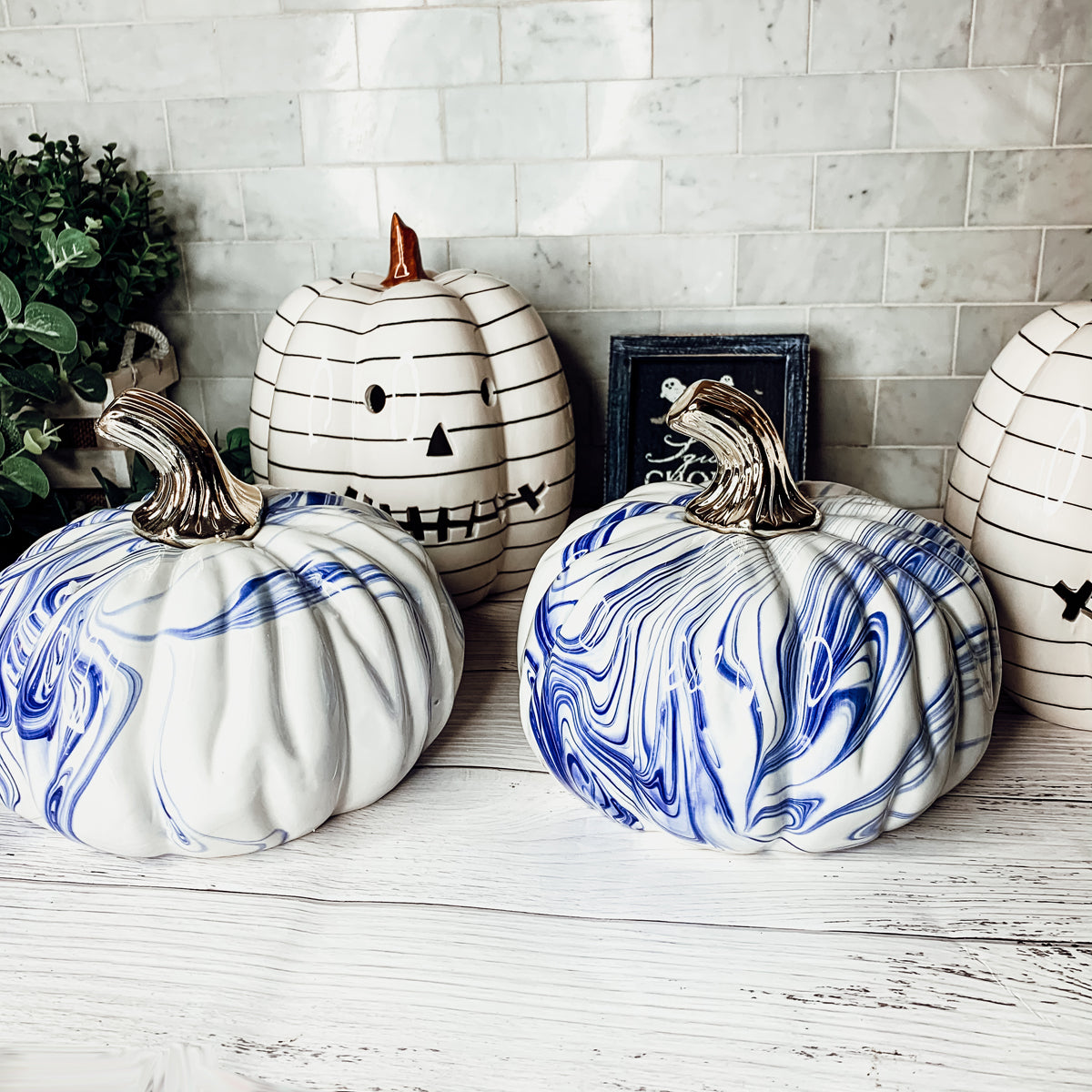 A stunning marbled blue pumpkin, handcrafted from dolomite, showcasing unique designs and elegant curves, perfect for Halloween decor.