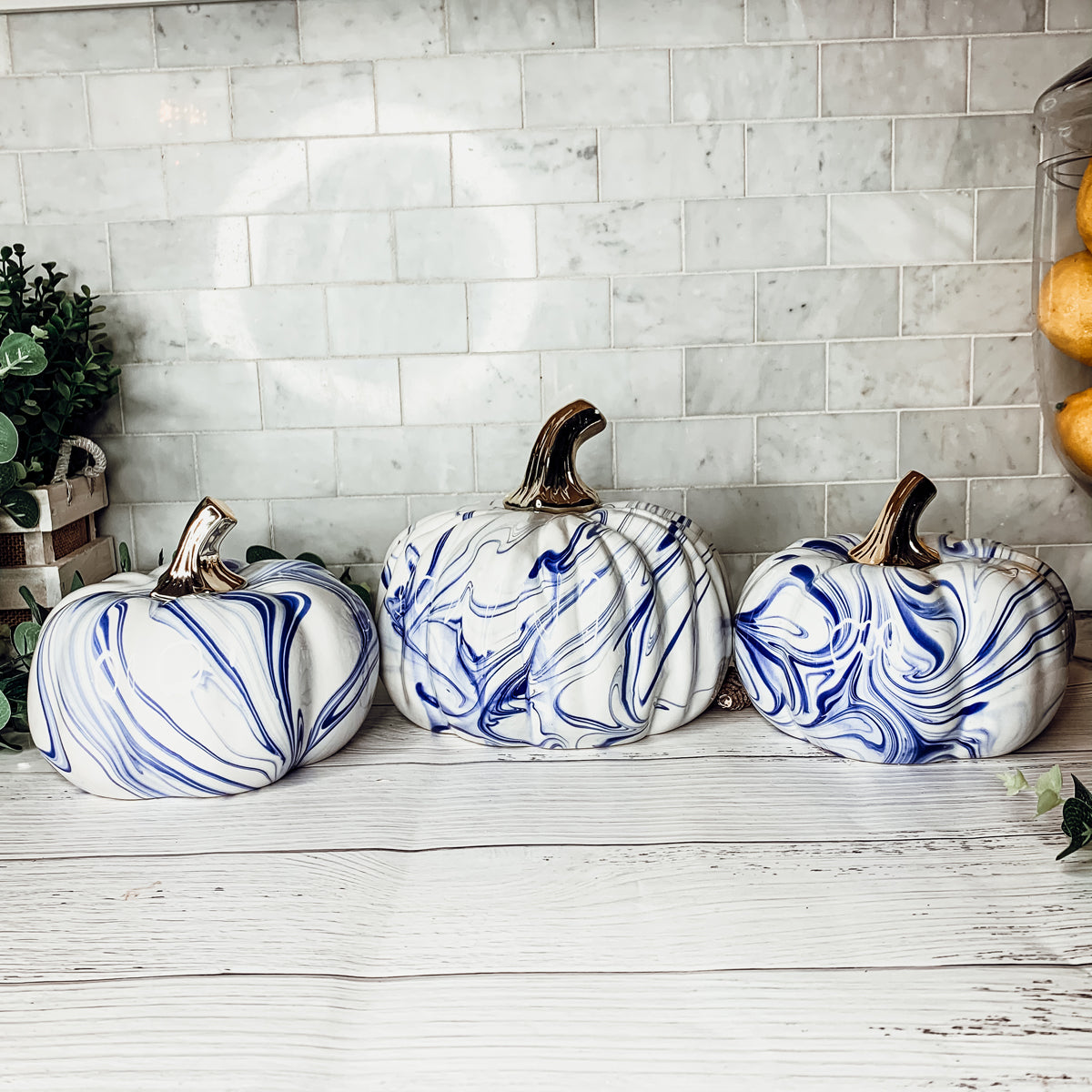 A stunning marbled blue pumpkin, handcrafted from dolomite, showcasing unique designs and elegant curves, perfect for Halloween decor.