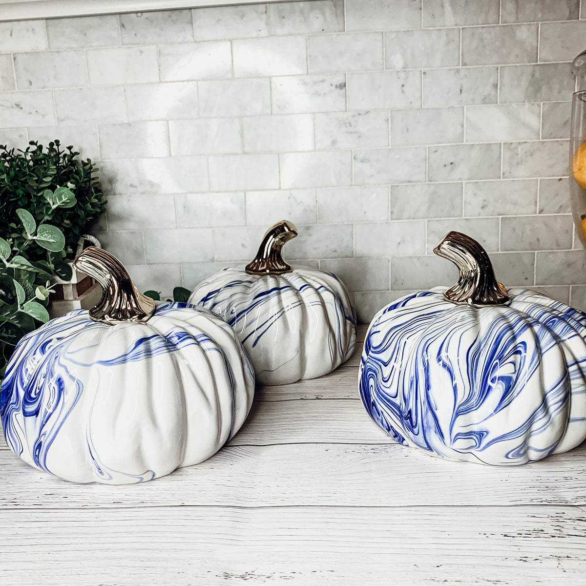 A stunning marbled blue pumpkin, handcrafted from dolomite, showcasing unique designs and elegant curves, perfect for Halloween decor.