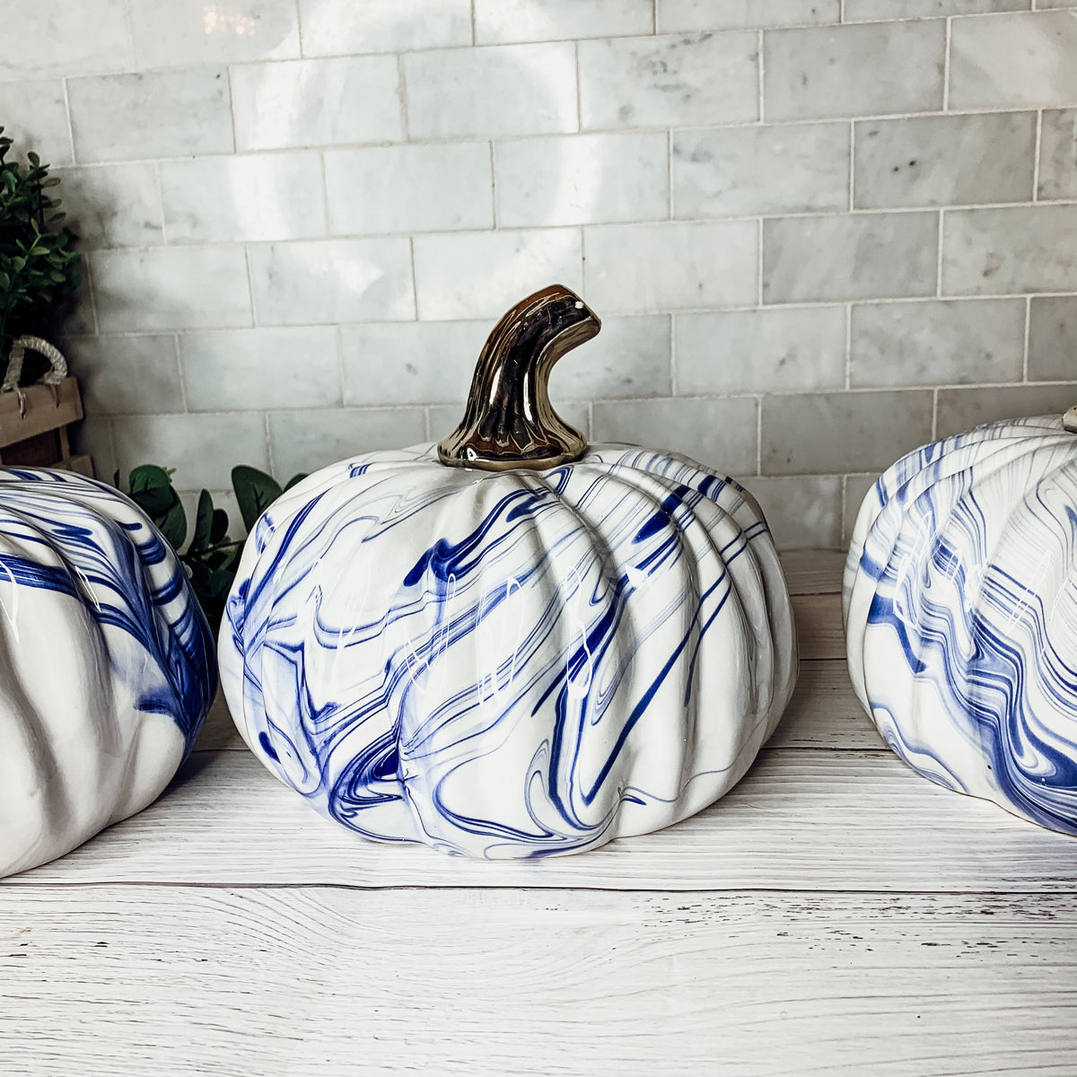 A stunning marbled blue pumpkin, handcrafted from dolomite, showcasing unique designs and elegant curves, perfect for Halloween decor.