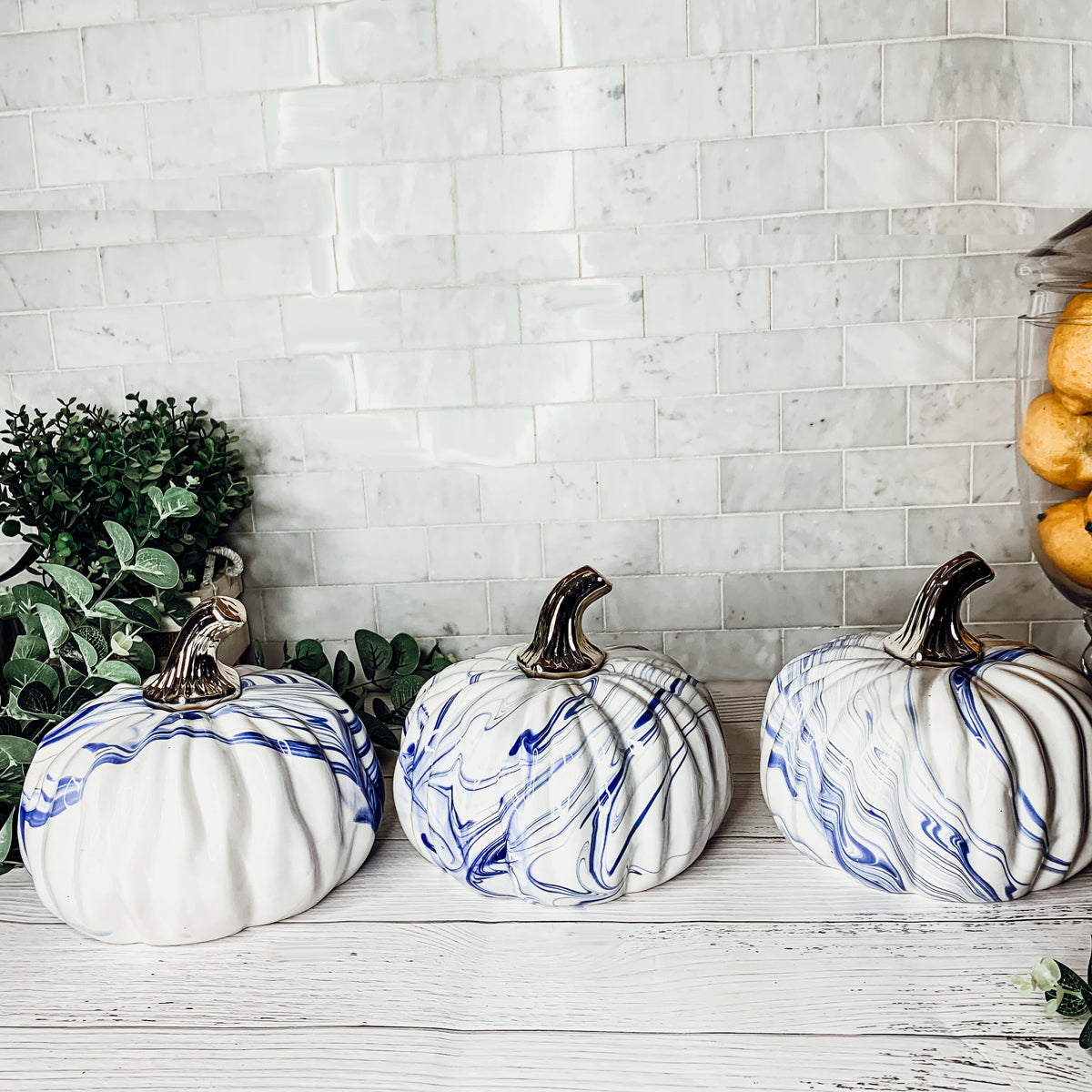 A stunning marbled blue pumpkin, handcrafted from dolomite, showcasing unique designs and elegant curves, perfect for Halloween decor.