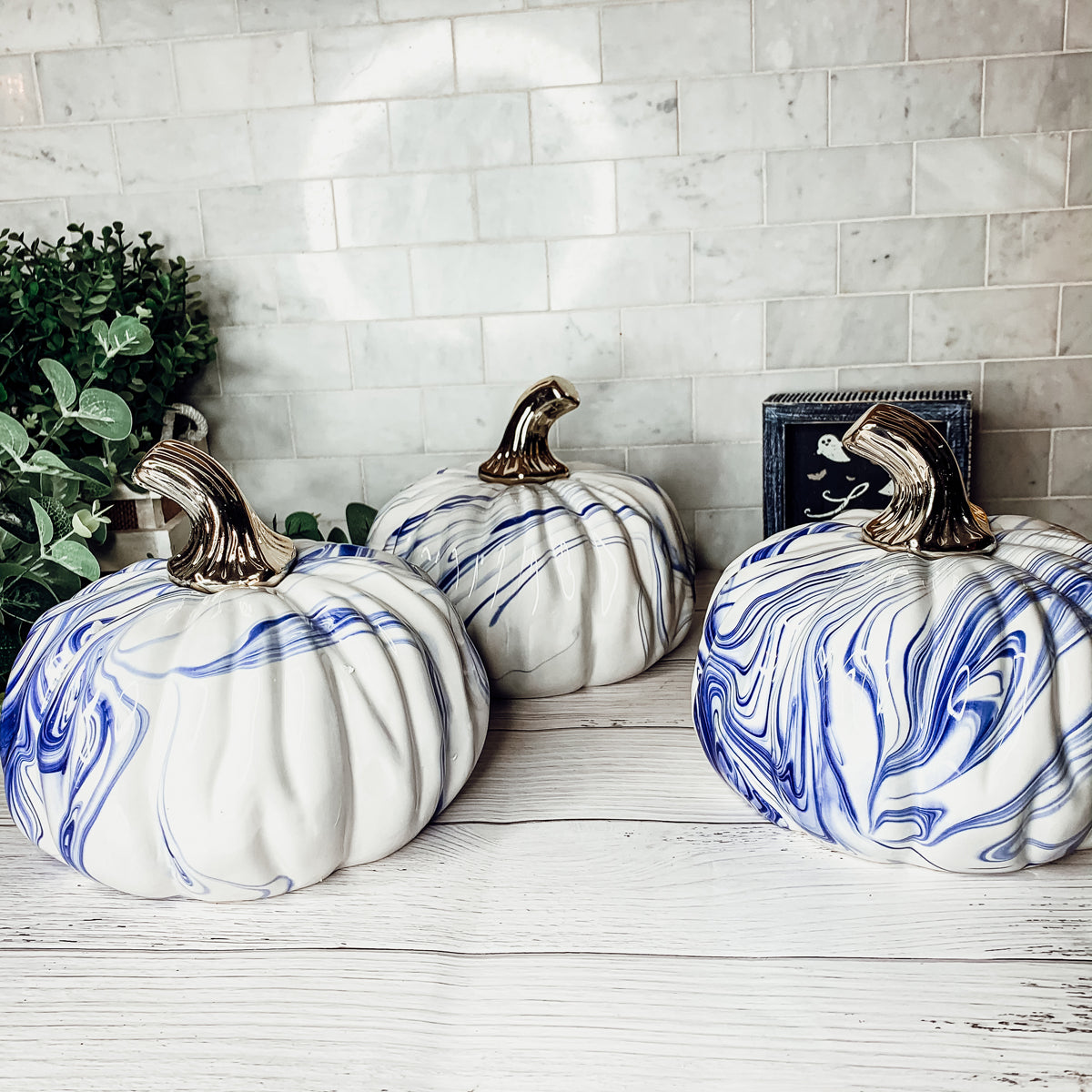 A stunning marbled blue pumpkin, handcrafted from dolomite, showcasing unique designs and elegant curves, perfect for Halloween decor.