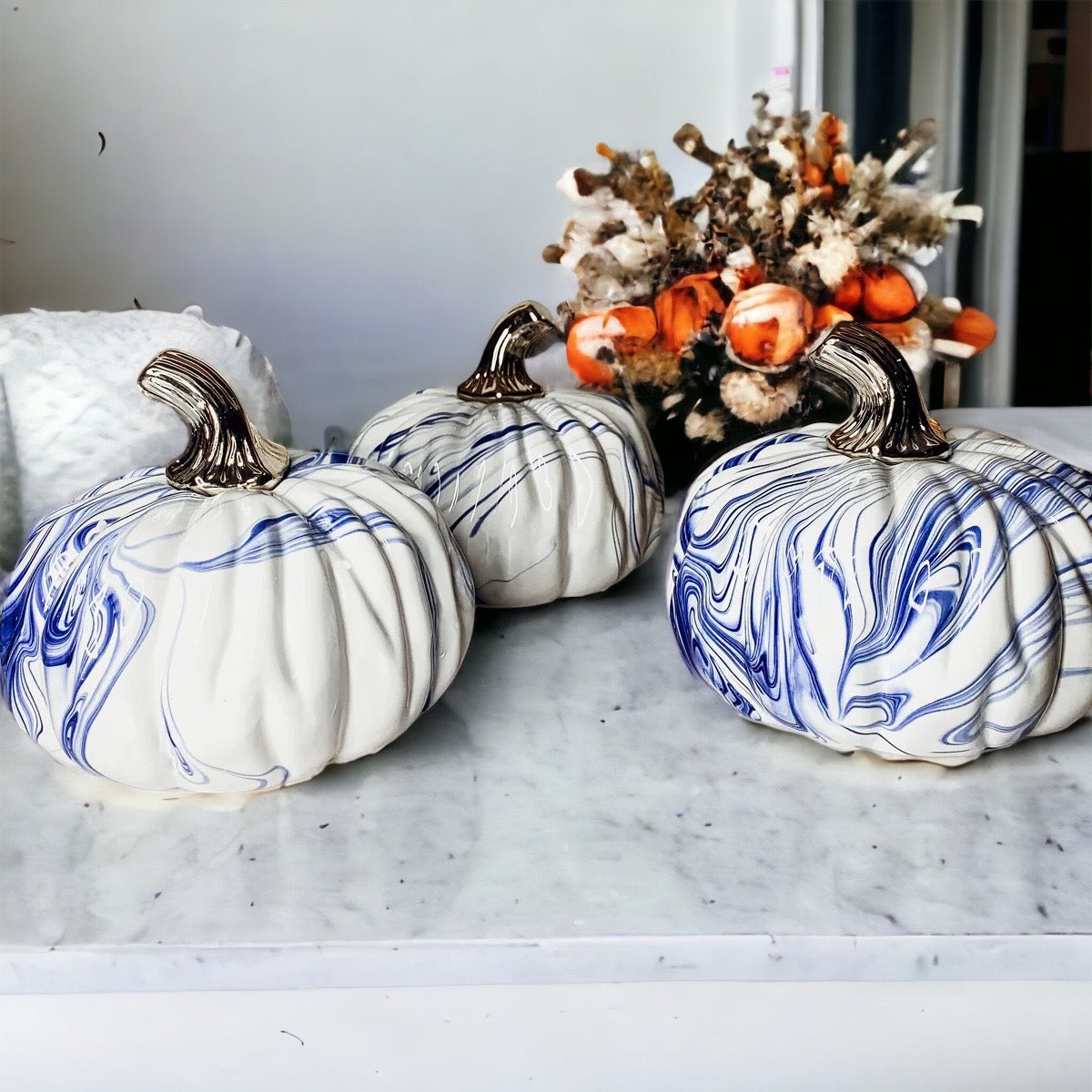 A stunning marbled blue pumpkin, handcrafted from dolomite, showcasing unique designs and elegant curves, perfect for Halloween decor.