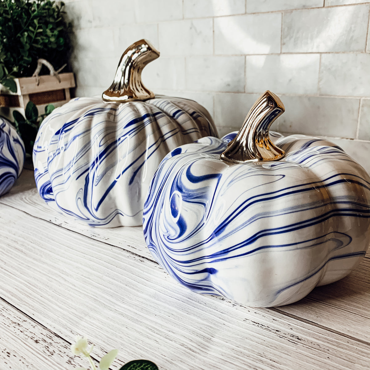 A stunning marbled blue pumpkin, handcrafted from dolomite, showcasing unique designs and elegant curves, perfect for Halloween decor.