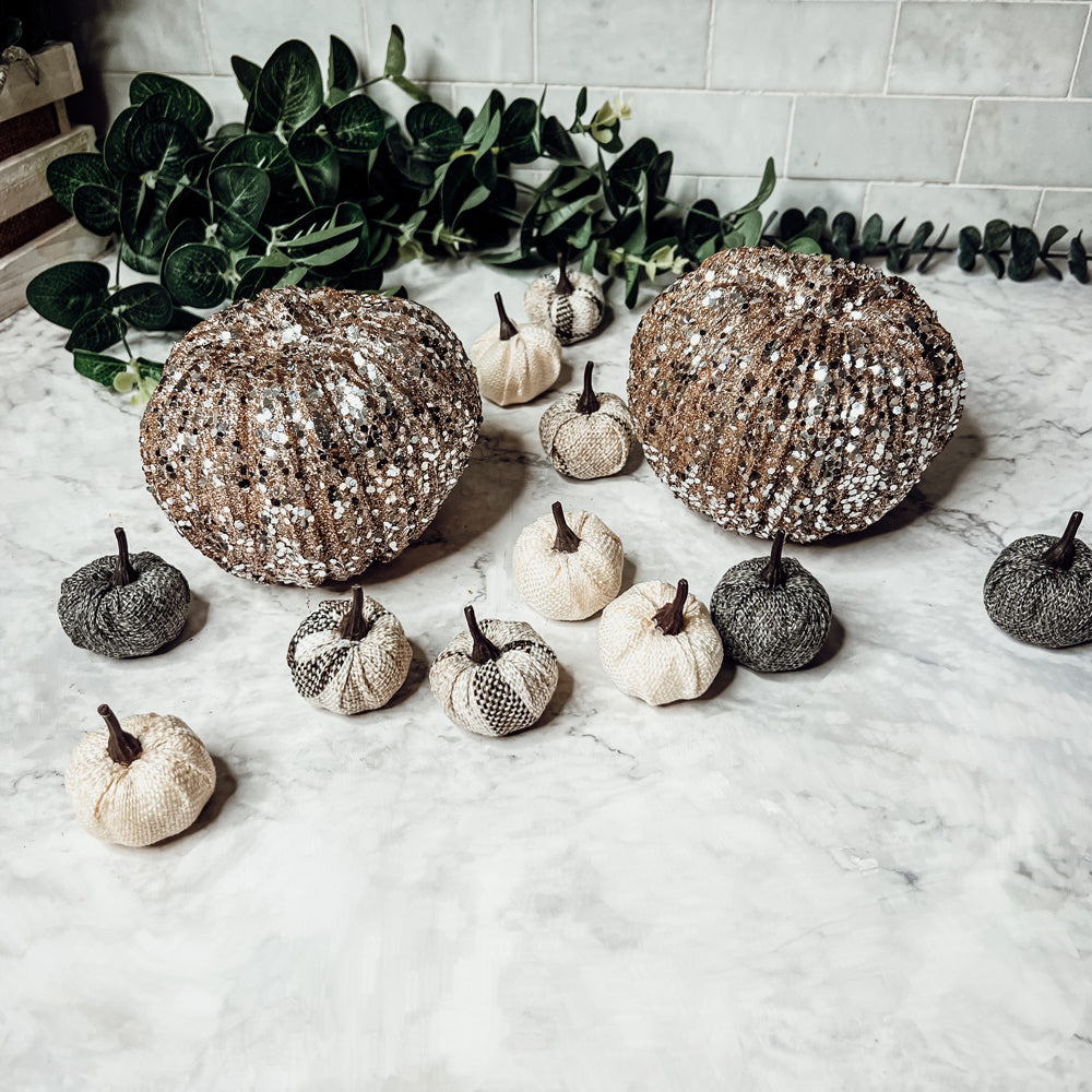 A collection of 12 mini pumpkins in beige, gray, and flannel patterns, perfect for fall and Halloween decor.