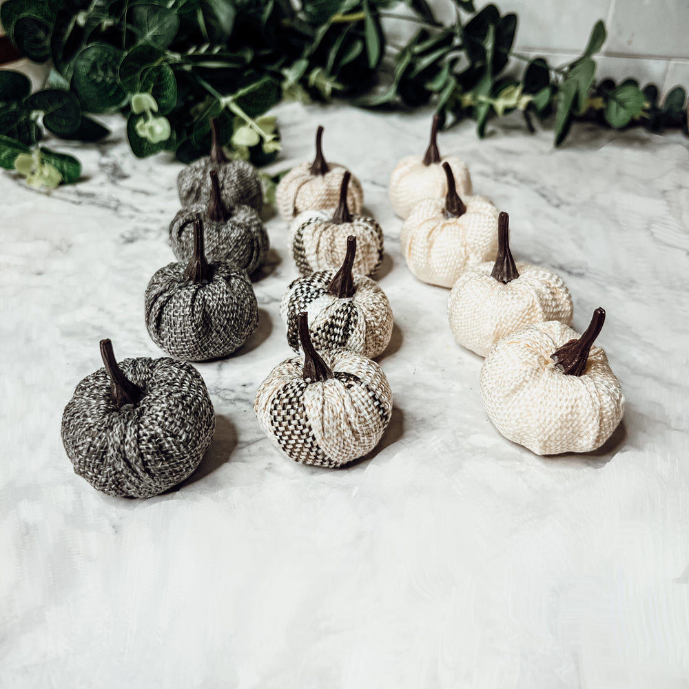 A collection of 12 mini pumpkins in beige, gray, and flannel patterns, perfect for fall and Halloween decor.