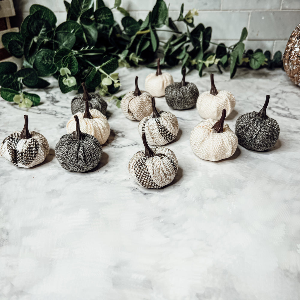 A collection of 12 mini pumpkins in beige, gray, and flannel patterns, perfect for fall and Halloween decor.