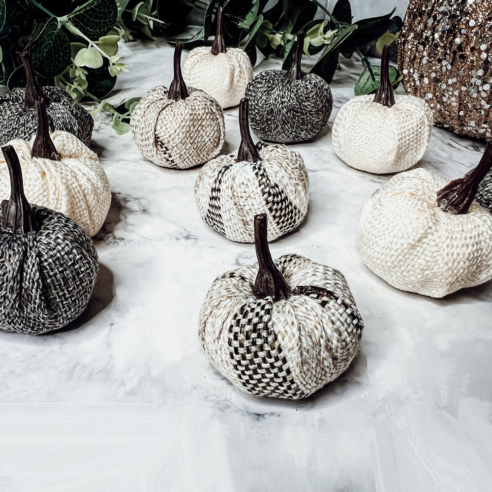 A collection of 12 mini pumpkins in beige, gray, and flannel patterns, perfect for fall and Halloween decor.